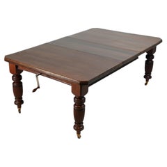 A British Colonial Dining Table on Casters with Extension Leaves