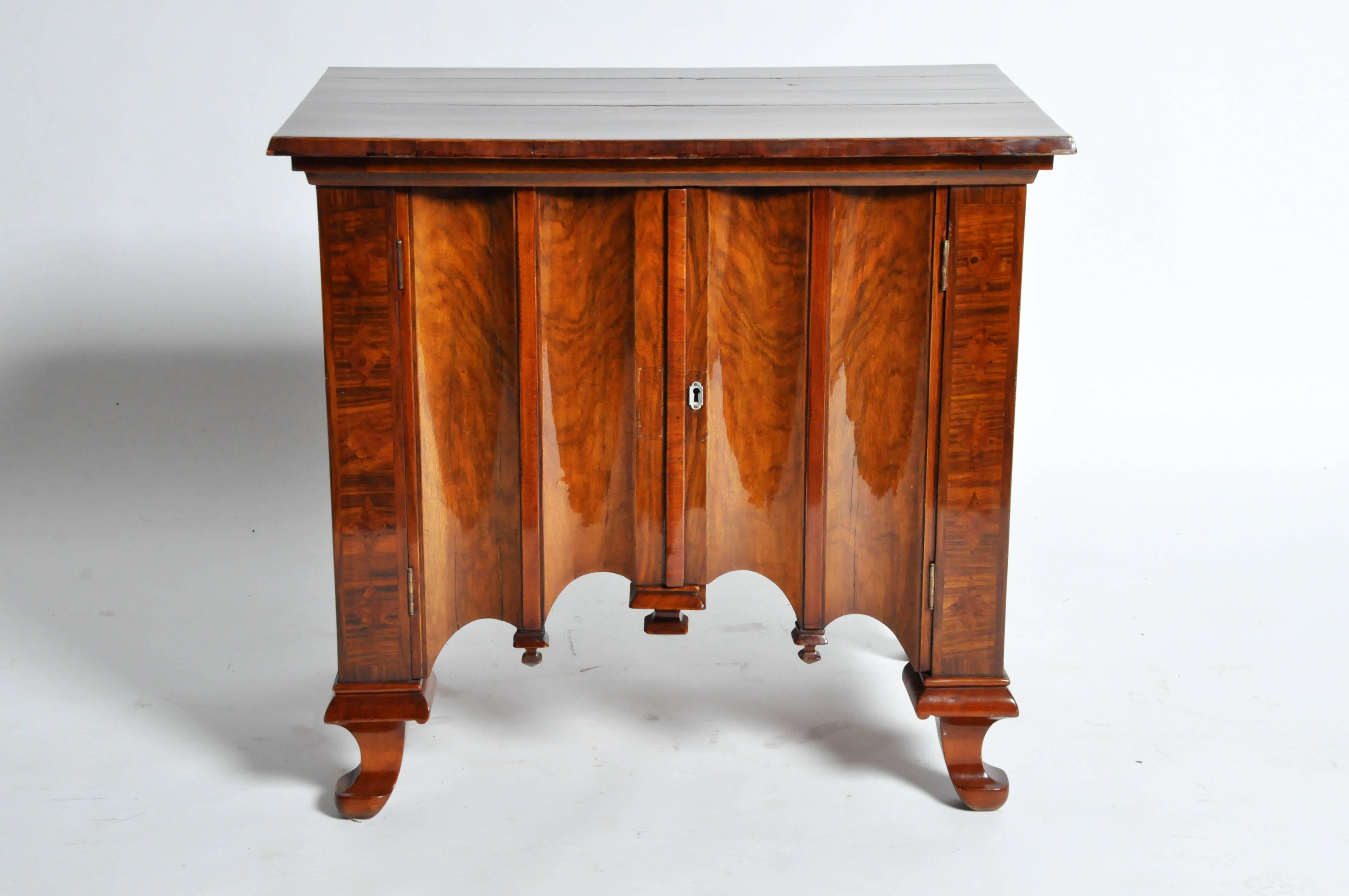 This neo-Gothic Hungarian side chest was designed by Lajos Kozma circa 1930s. It is made from walnut veneers and has a deeply scalloped profile. As is typical of Kozmas' work, this piece blends traditional and modern motifs.