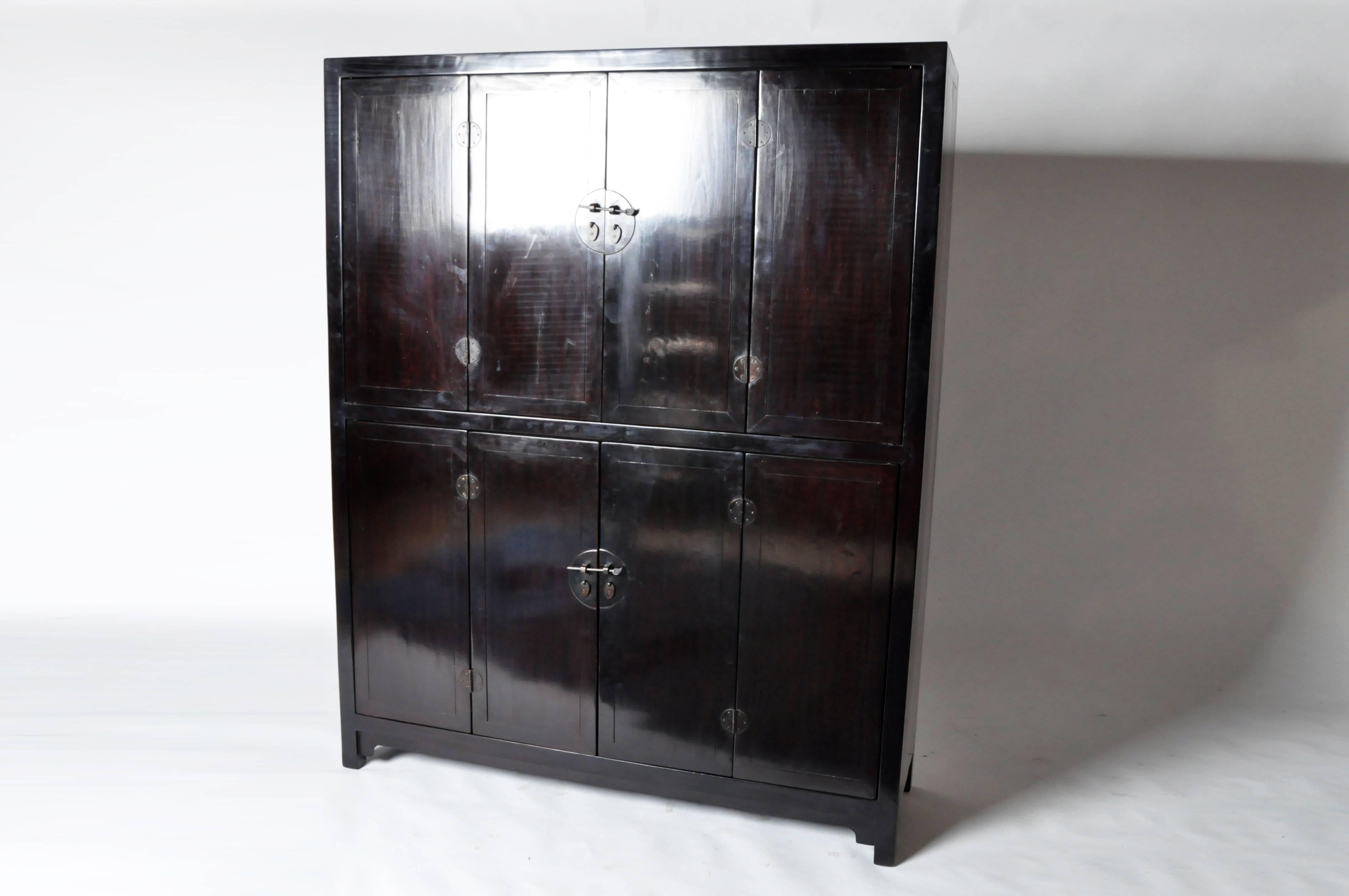 This eight-door Chinese cabinet is made from elmwood and has been fully restored. It features a shelf on both the top and bottom for ample storage.