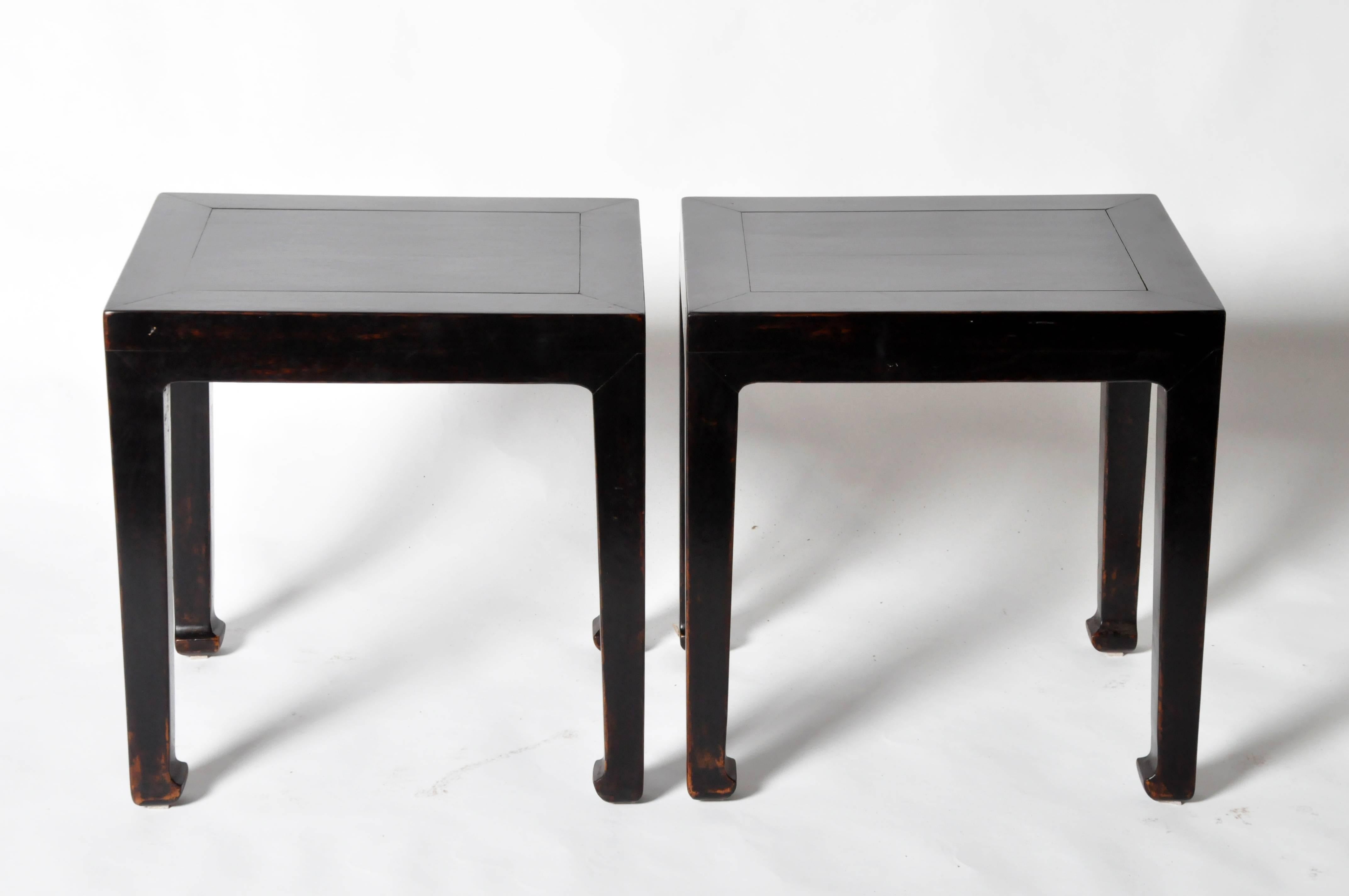 This pair of Chinese side tables are made from elmwood and has been fully restored. It features hoofed legs.