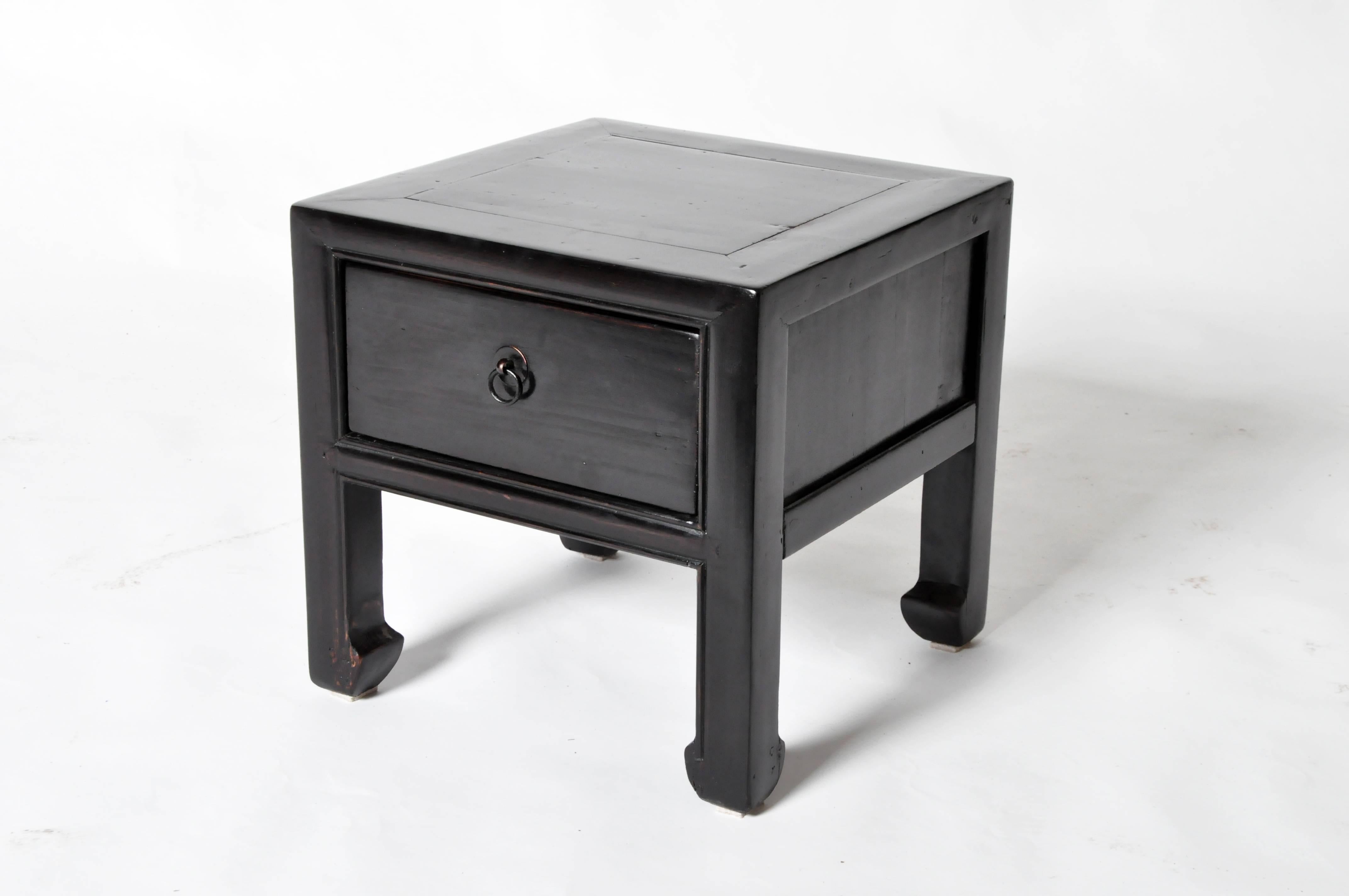 These Chinese stools are made from elmwood and has been fully restored. They each features one drawer and hoofed legs.