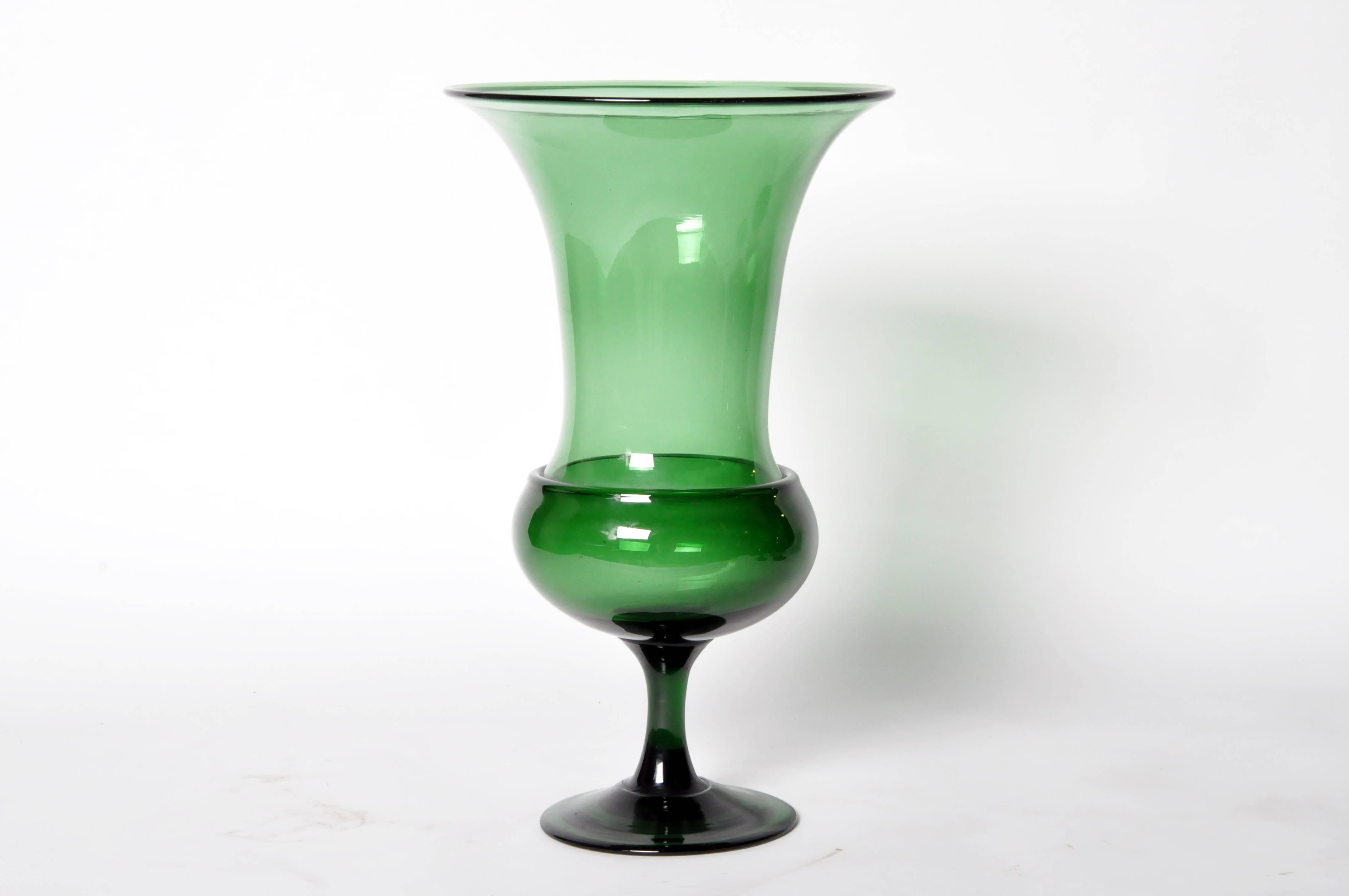 This large glass pedestal urn has a trumpet bell flared rim. In a group or Stand-alone they brighten any tabletop; the luminous emerald green perfectly pairs with fresh stems, fruit, pillar or votive candles.