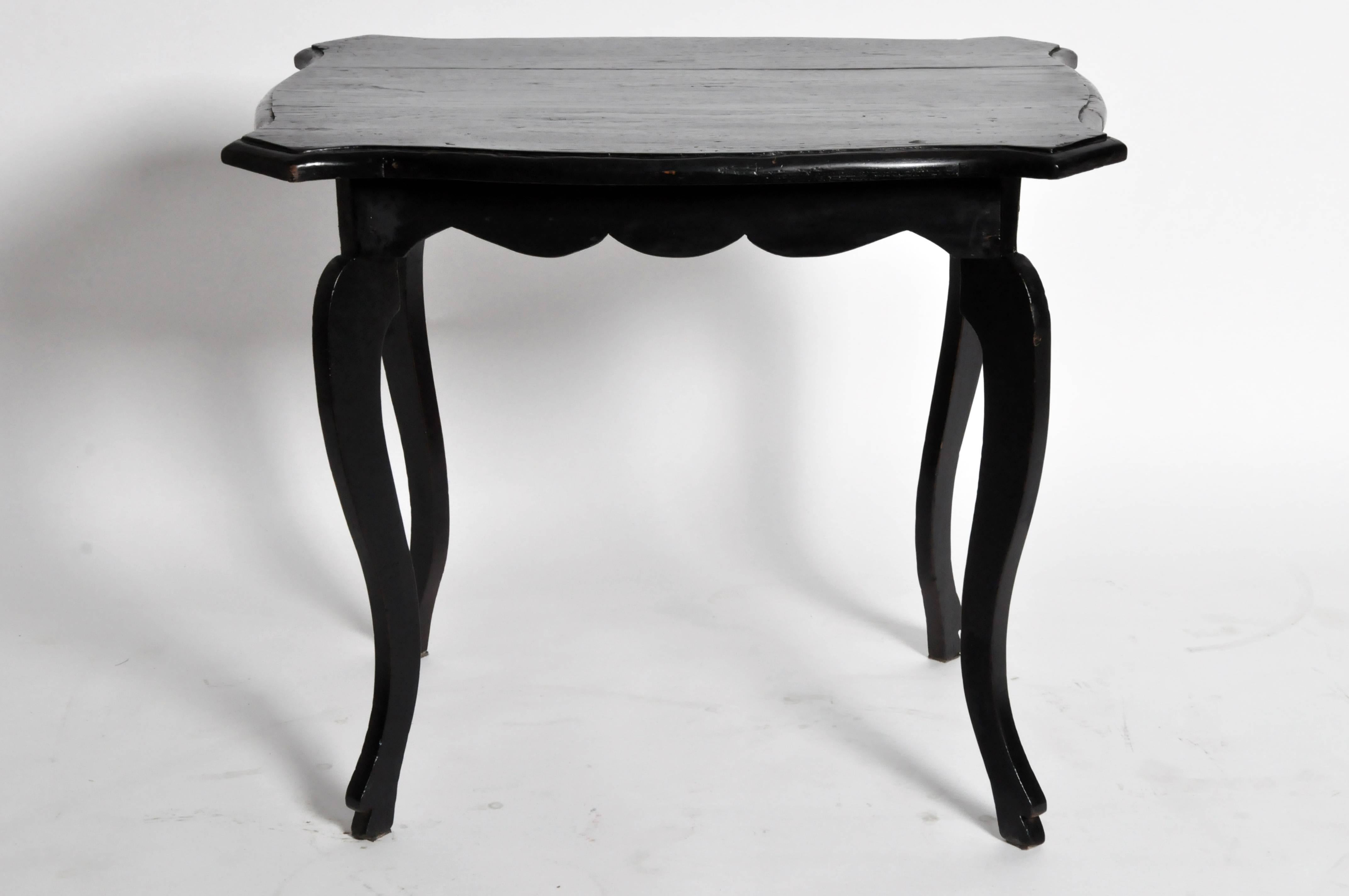 This British Colonial tea table is from Burma and is made from teakwood, circa 1900. It features a molded top and apron.