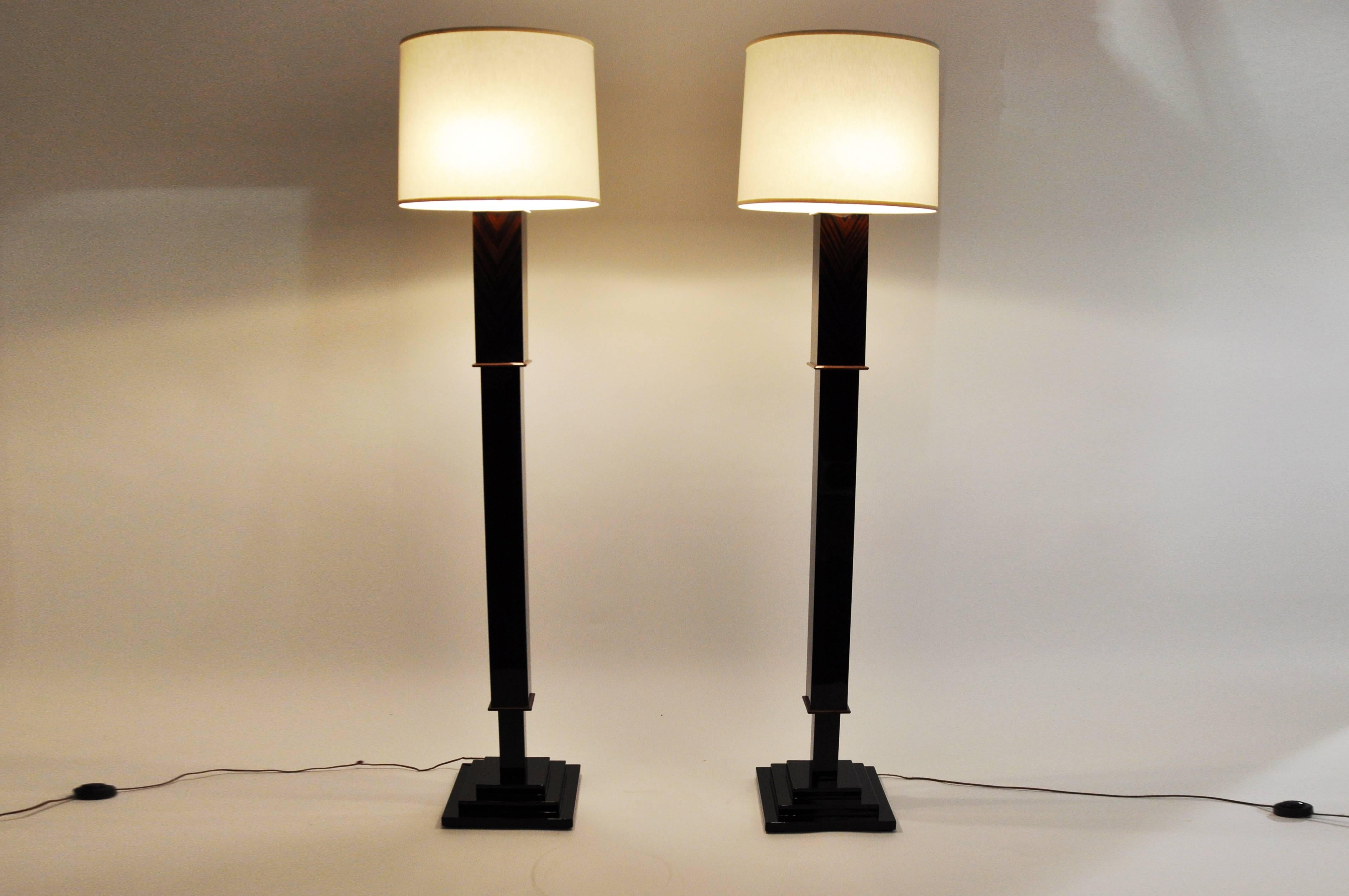 This elegant pair of floor lamps is from Hungary and is made from walnut veneer. They both feature a step base.