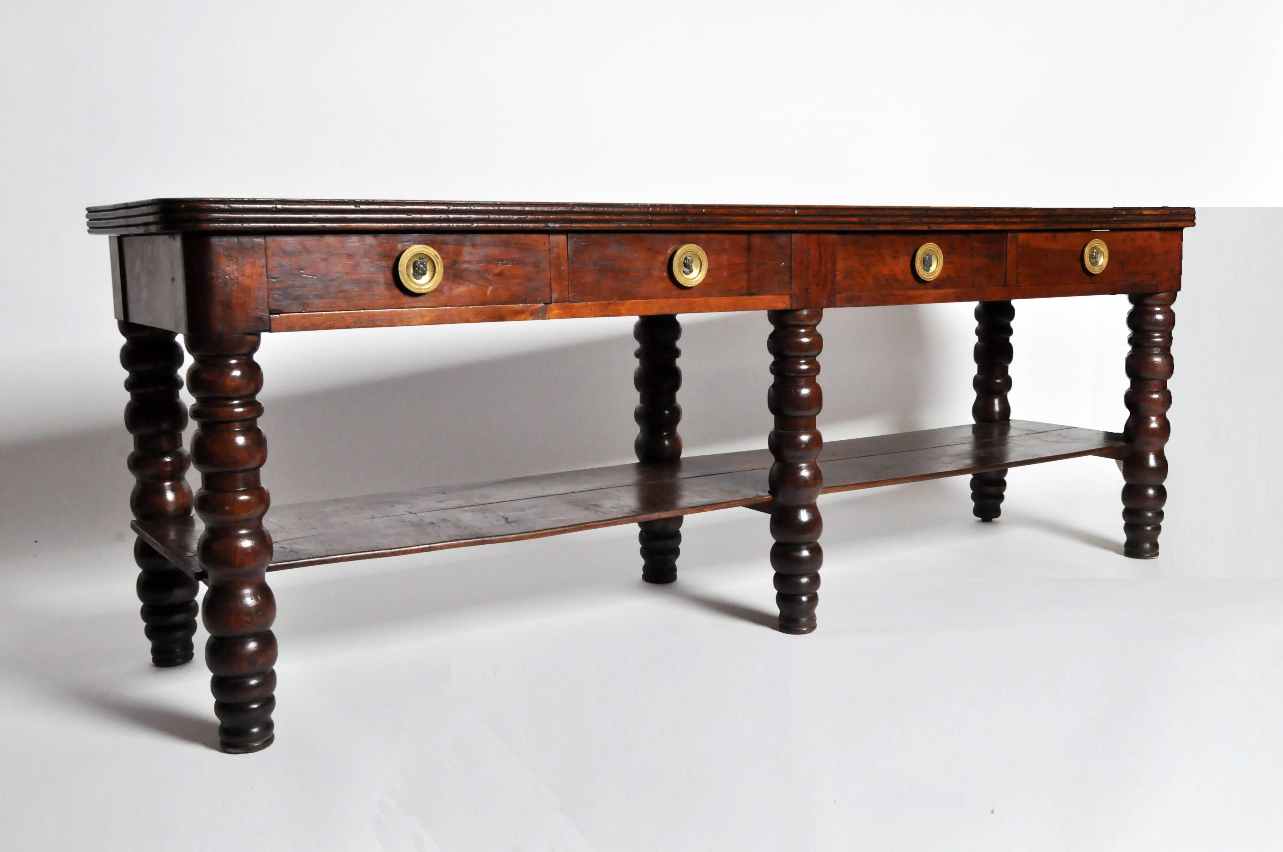 This impressive console table is from France and is made from walnut wood, circa 19th century. This console features a single piece top and original brass hardware.