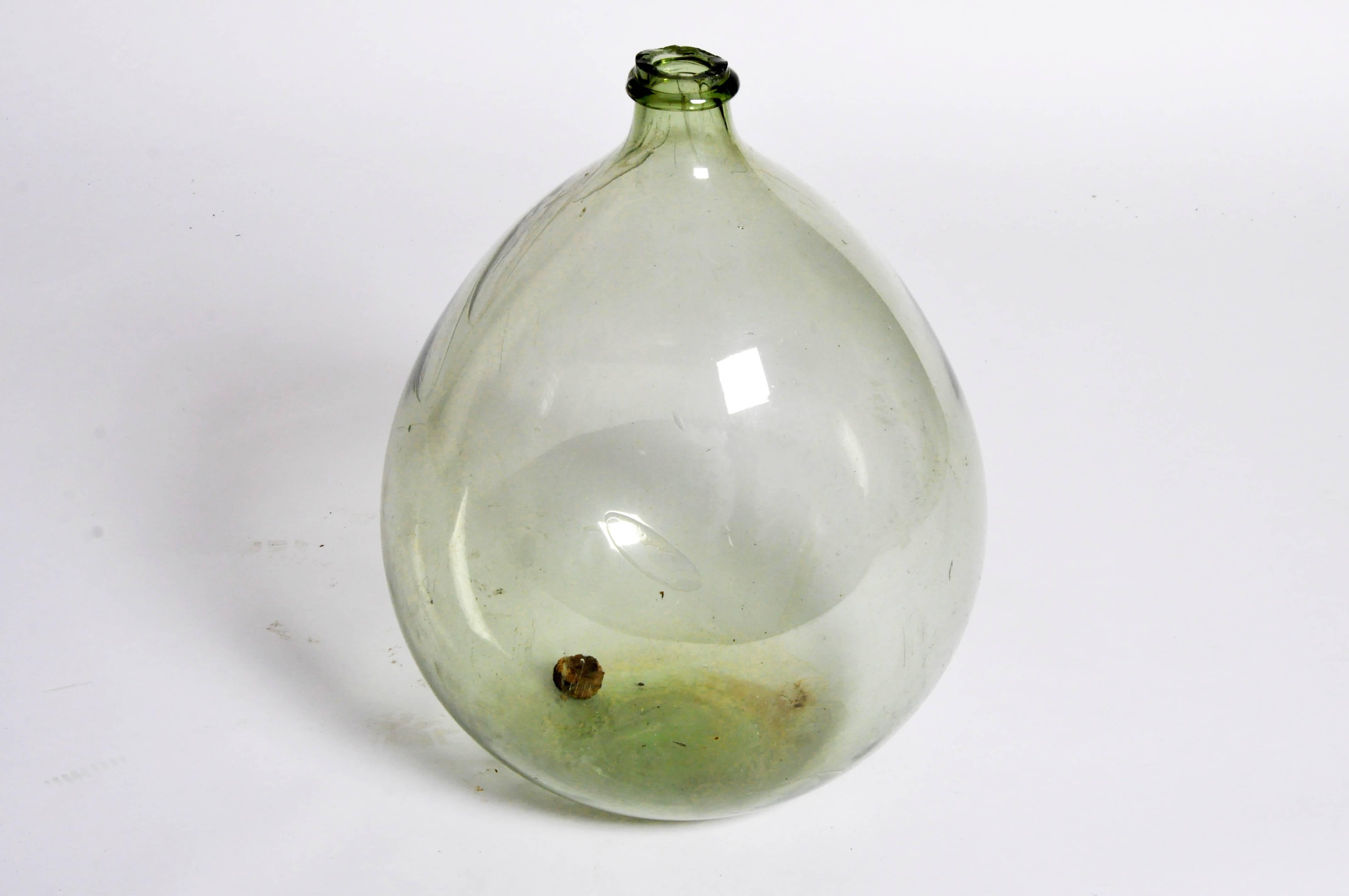This wine jar is from Barcelona, Spain, and is made from glass, circa 20th century.