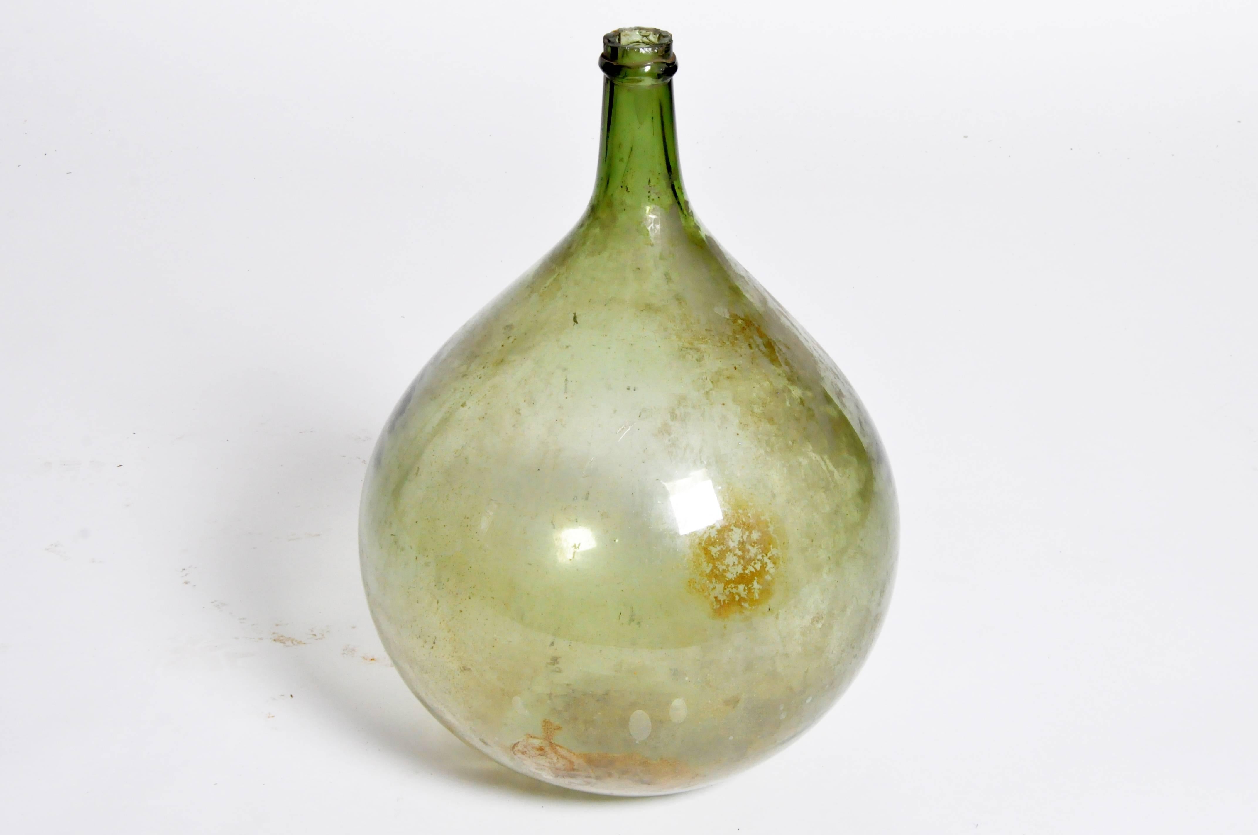 This olive jar is from Spain and is made from handblown glass, circa 19th century.
