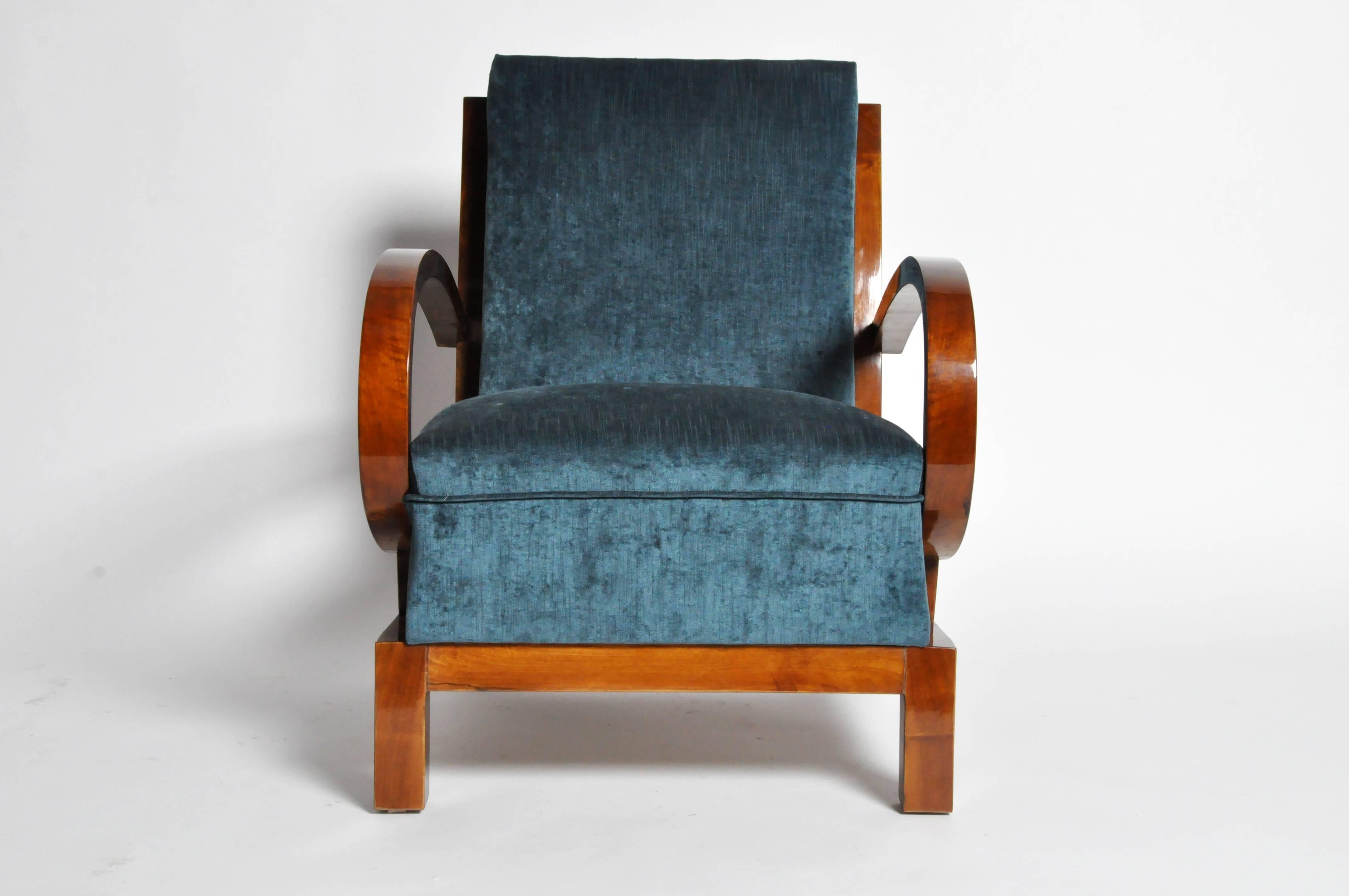 This handsome pair of armchairs are from Budapest, Hungary and are made from solid walnut, circa 1930.