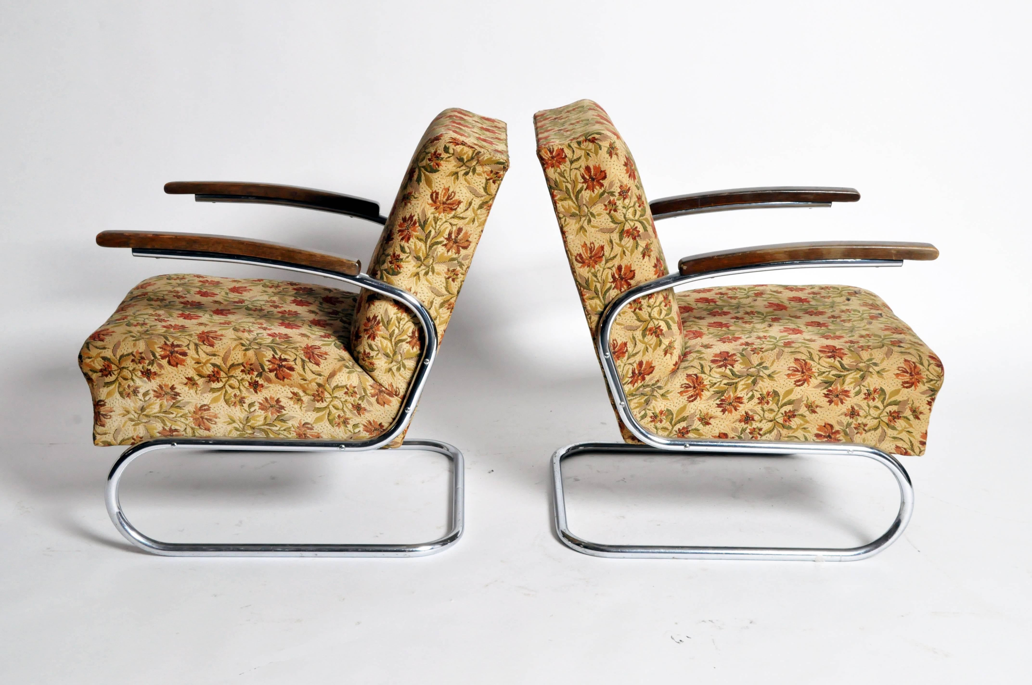 This elegant pair of chairs are from Hungary and made from walnut and chrome.