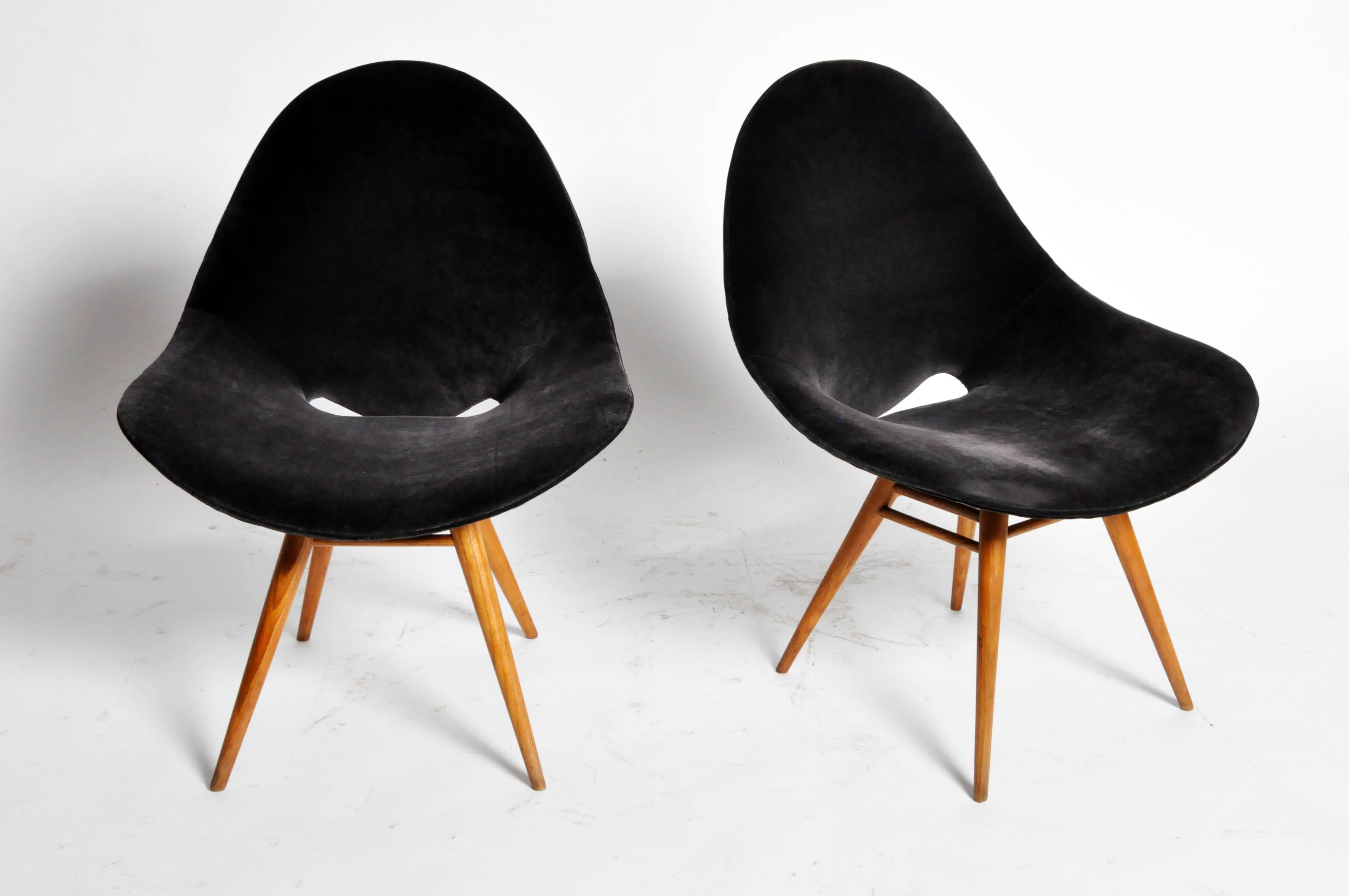 This handsome pair of Italian style eggshell-shape chairs are from Italy, circa 1970.