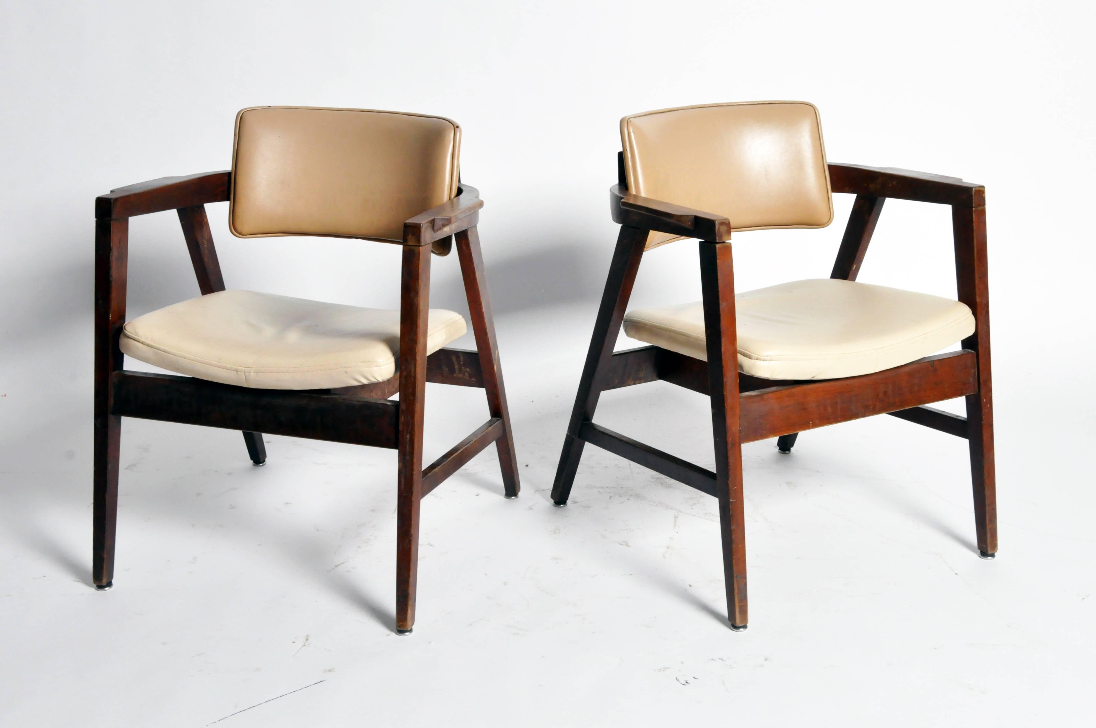 These Mid-Century armchairs are from France and are made from solid walnut, circa 1950.