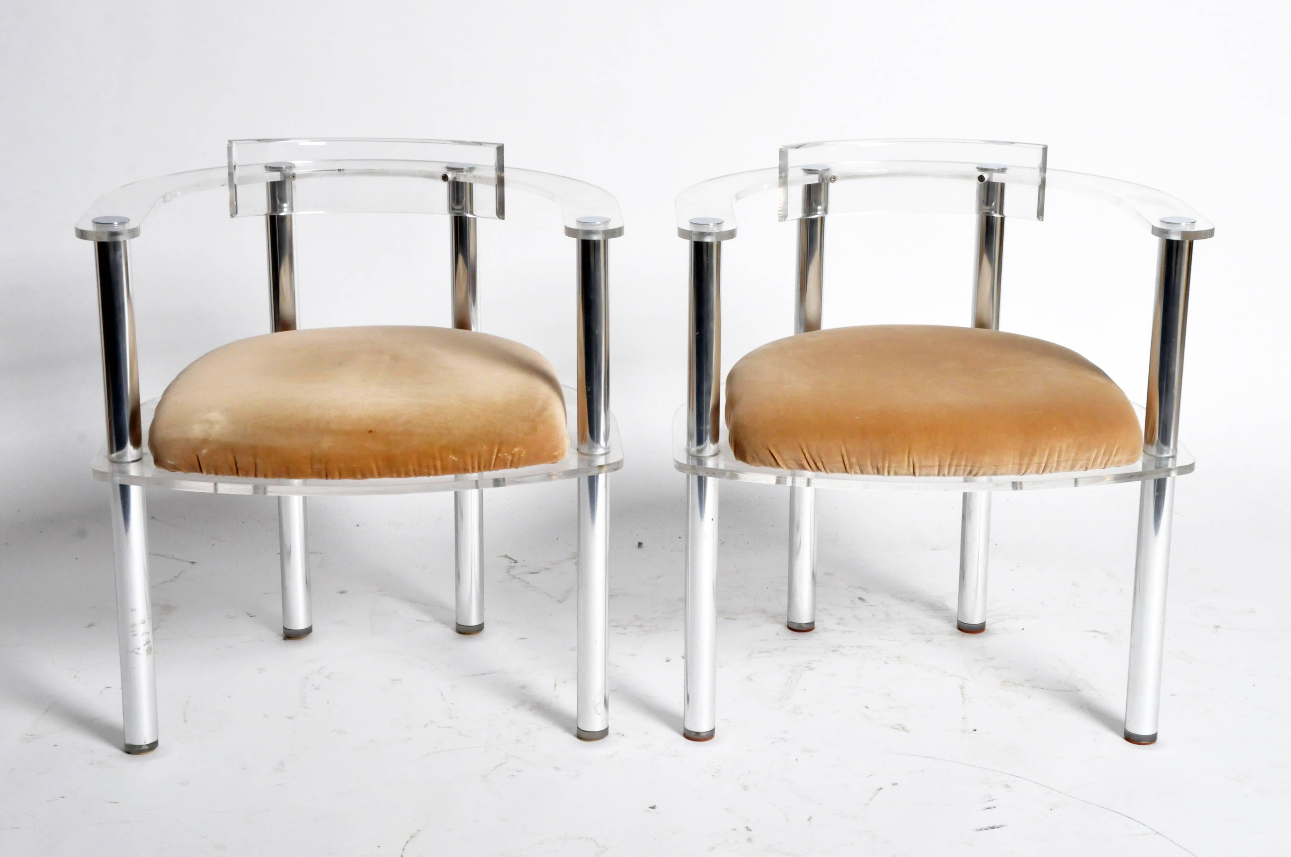 These unique Mid-Century chairs are from Paris, France and are made from plexiglass and metal.