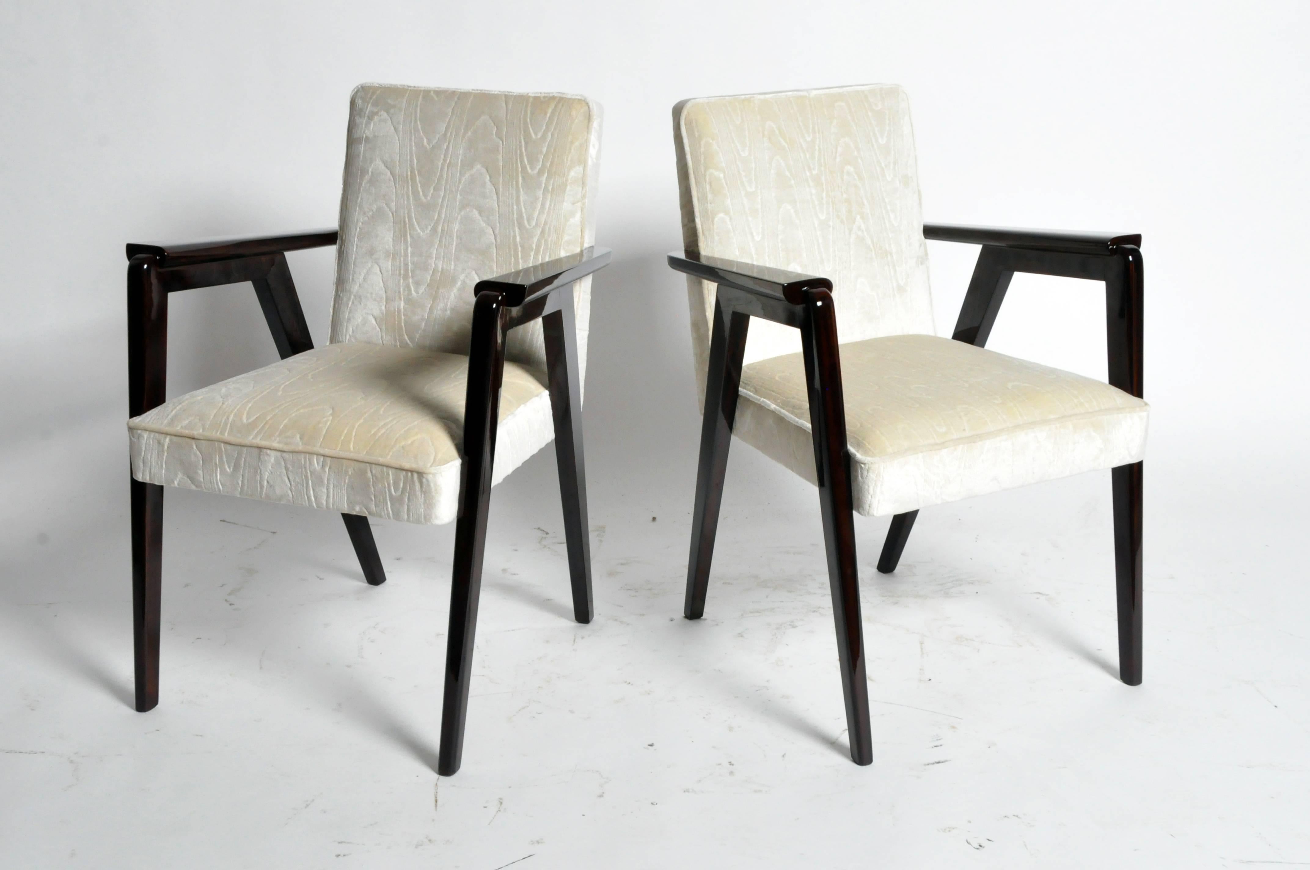 Pair of Vintage French bridge chairs. Beautiful, modernist lines and sturdy framework. The wavy, tilde shaped arm rails and gently rounded edges on the legs of these chairs softens the angularity of their frames.