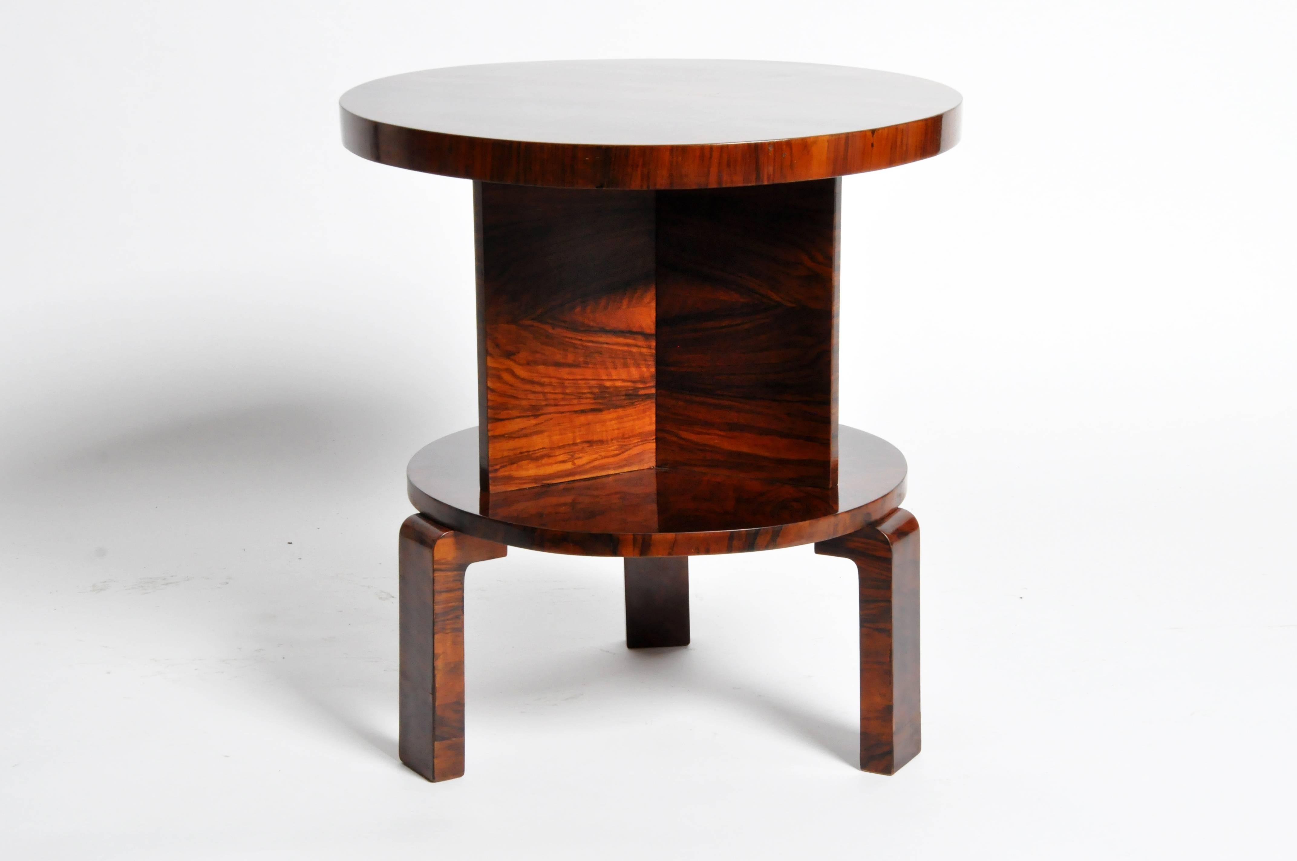 This handsome Art Deco round table is from Budapest, Hungary and is made from walnut veneer and features a shelf.