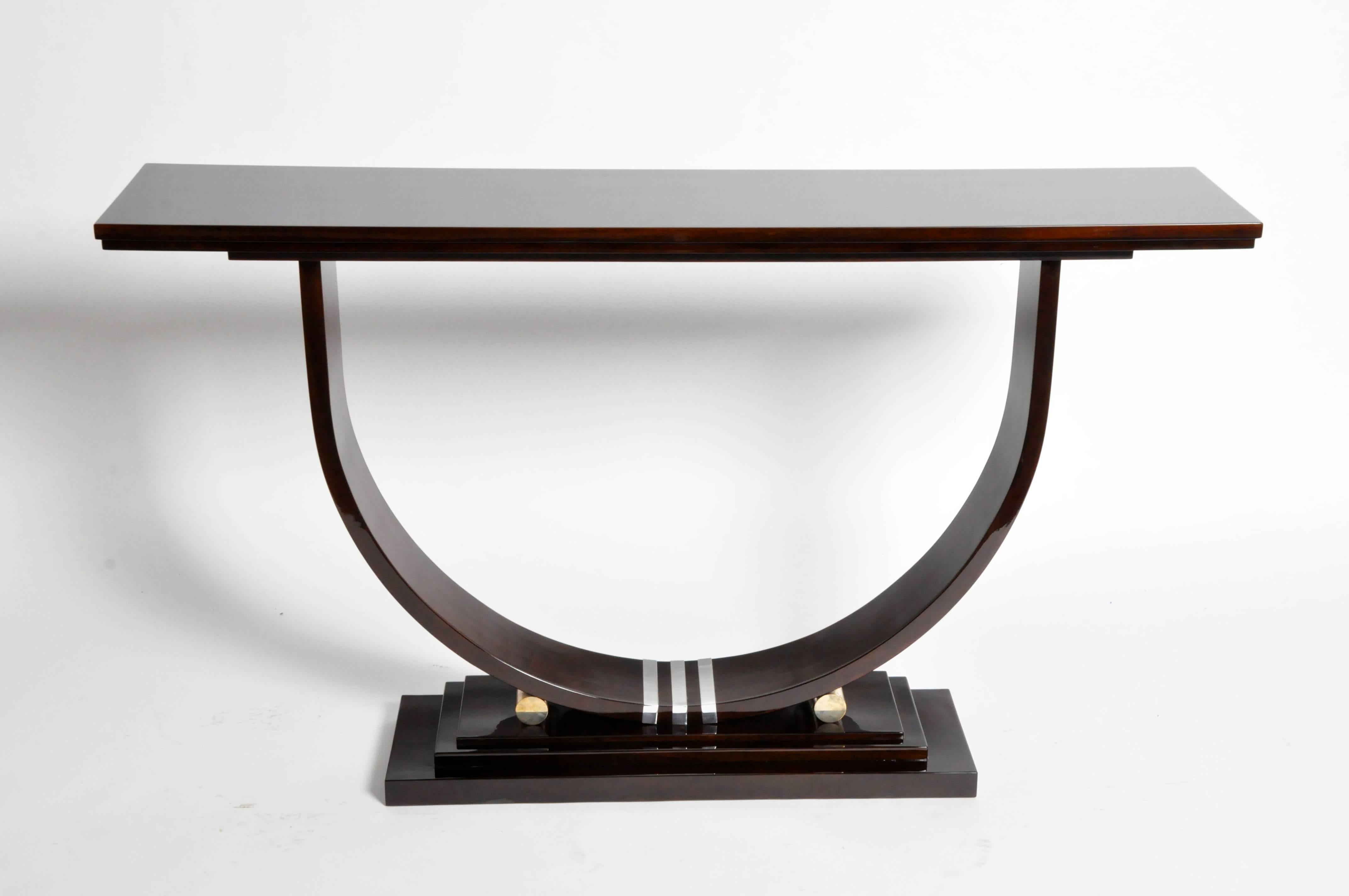 Stunning Mid-Century style console with dark walnut veneer and chrome accents. This piece imparts a chic, architectural elegance with its fine lines and u-shaped base.