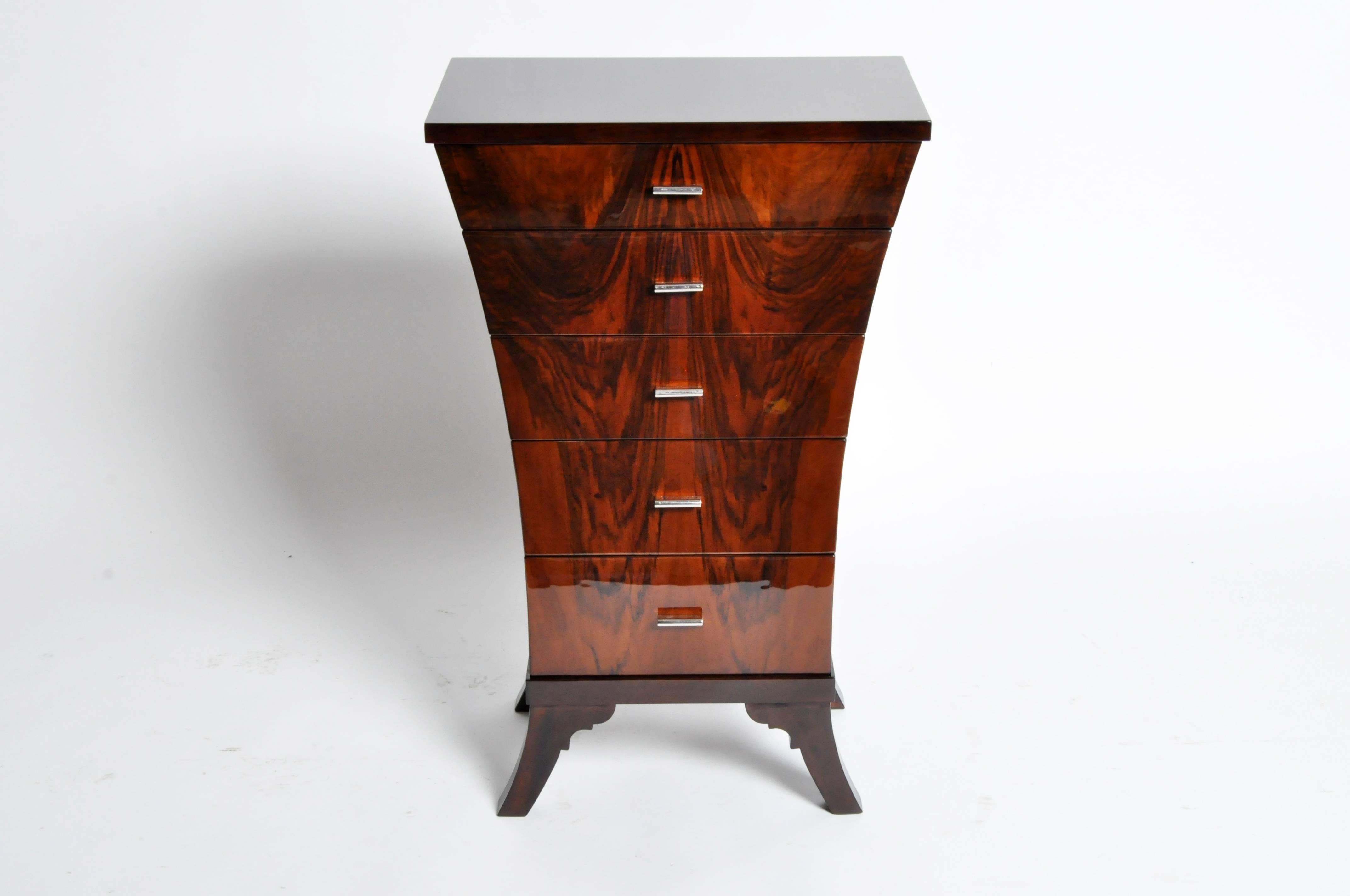 This gorgeous newly made Art Deco style chest of drawers is from Hungary and is made from walnut veneer. This piece features curved sides and elegant clean lines.