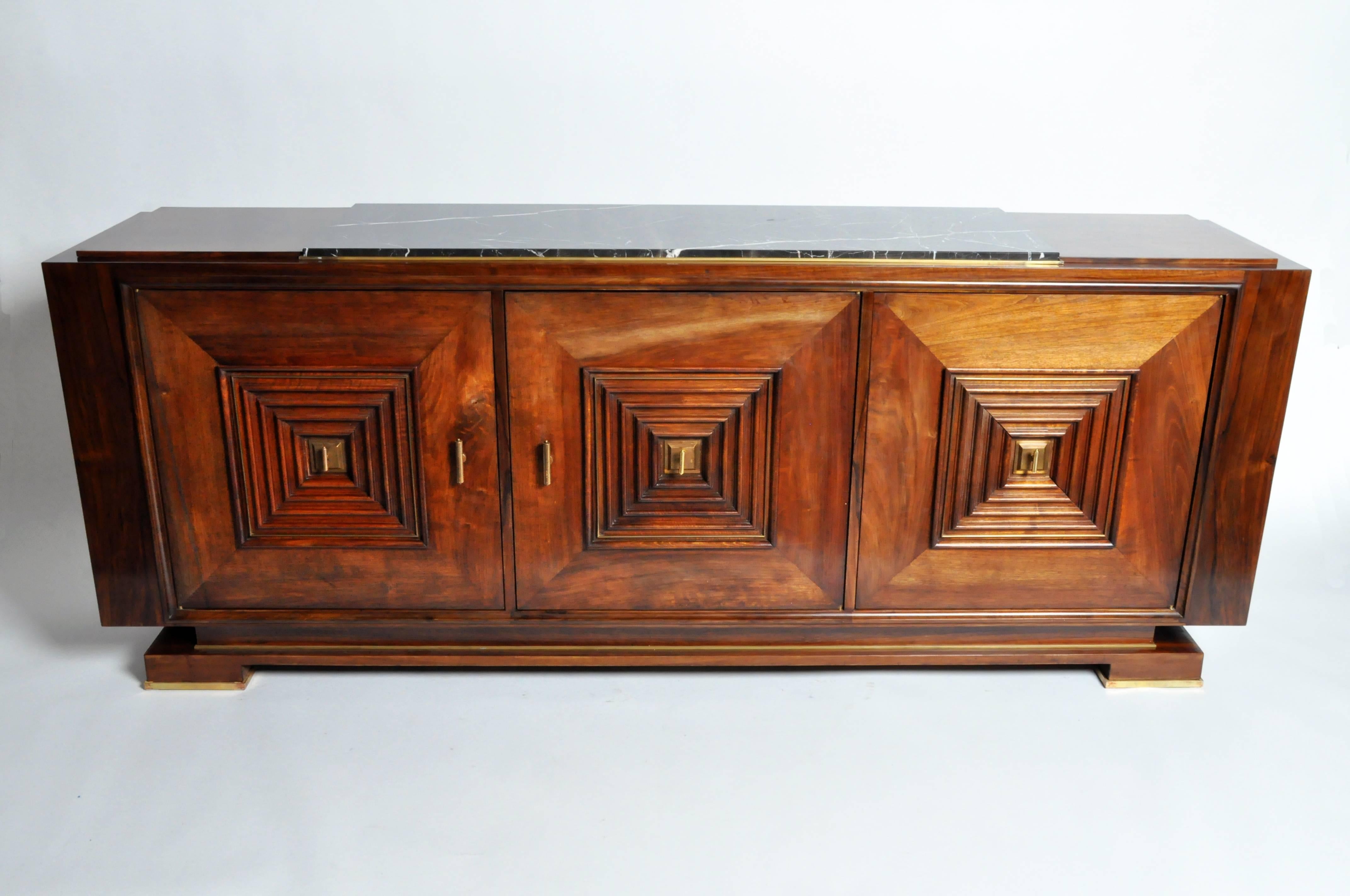 Stunning hardwood console . Featuring three block panels with radiating geometric motifs, this piece draws on the precision of line and sparing elegance of Greco-Roman Classicism. A statement piece that is sure to make a beautiful addition to any