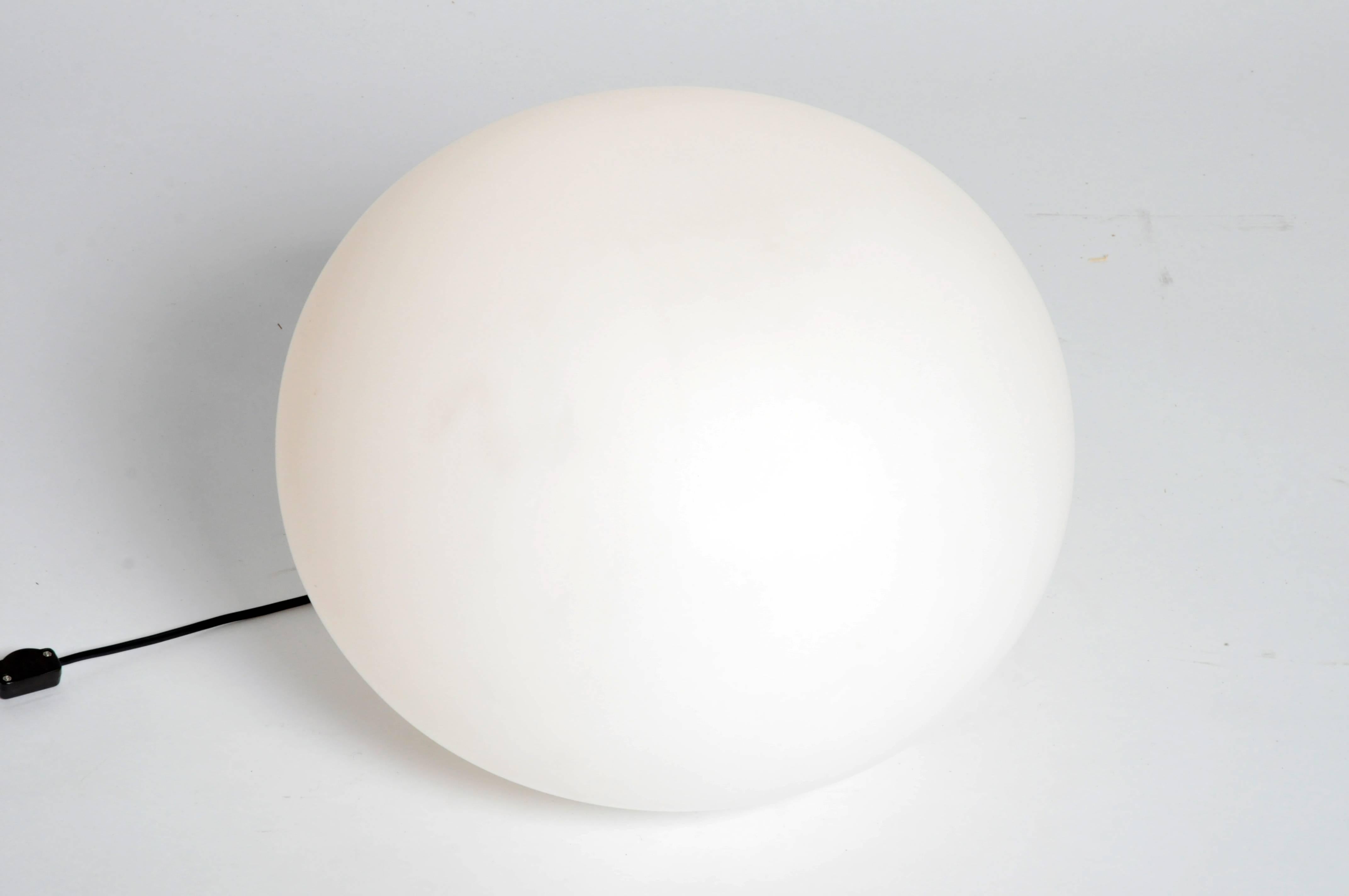 Made from handblown opaline glass these lights are expertly crafted and emit a soft nebulous glow. The gently compressed globes are secured to circular white metal bases. Chic additions to any modern interior, we also think they look exquisite on a