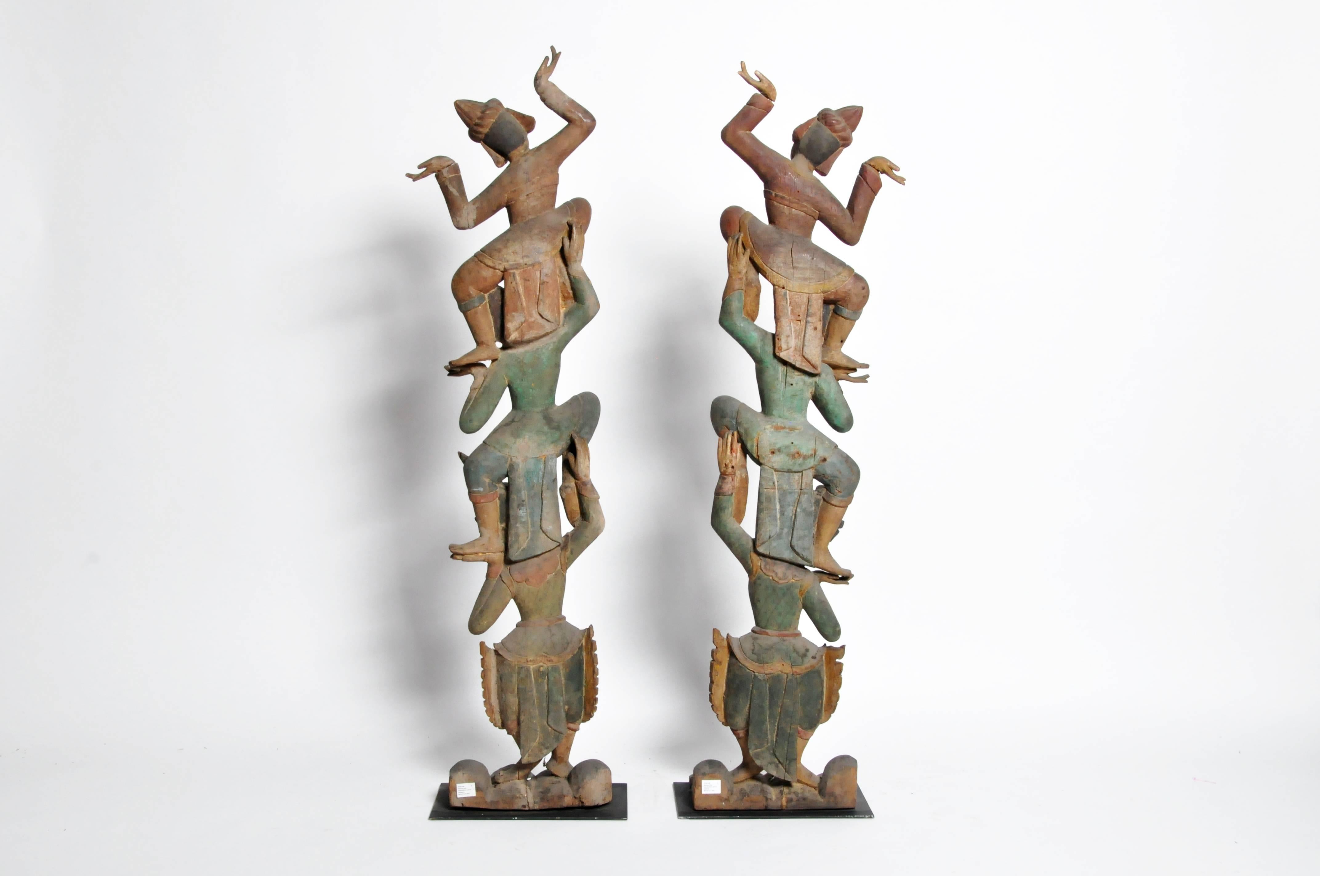 These handsome hand-carved Thai dancers are from Chiang Mai, Thailand, circa late 20th century. Carved from teak wood they have been mounted on a metal base for display.