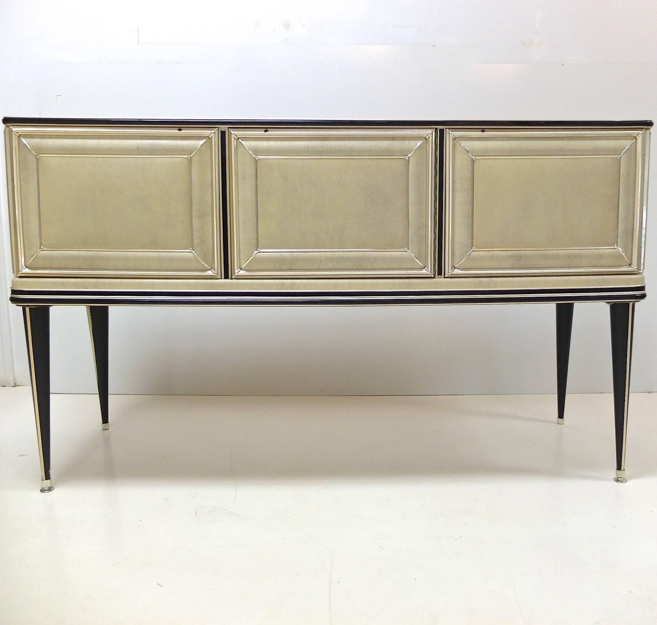 Early 1950s sideboard created by Umberto Mascagni of Bologna, Italy, imported to the UK by I. Barget and retailed through Harrod's, London, 1952-1955. Mascagni was known for his provocative use of new materials in furniture designs such as skai