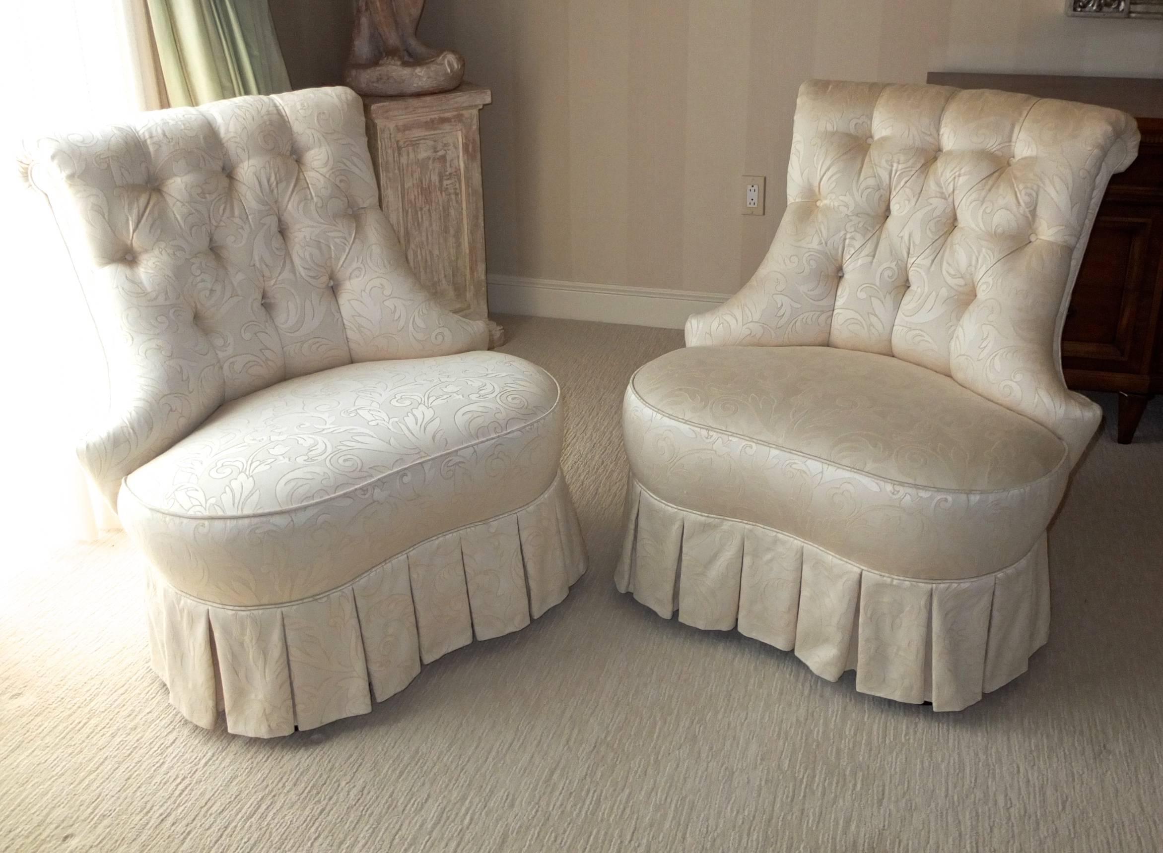 Pair of custom Karges spring seat crescent shaped slipper chairs. Hand diamand tufted backs with self cover buttons and dressmaker skirt tailoring in ivory damask Brunschwig & Fils leaf pattern upholstery. Excellent condition. No stains or fading.