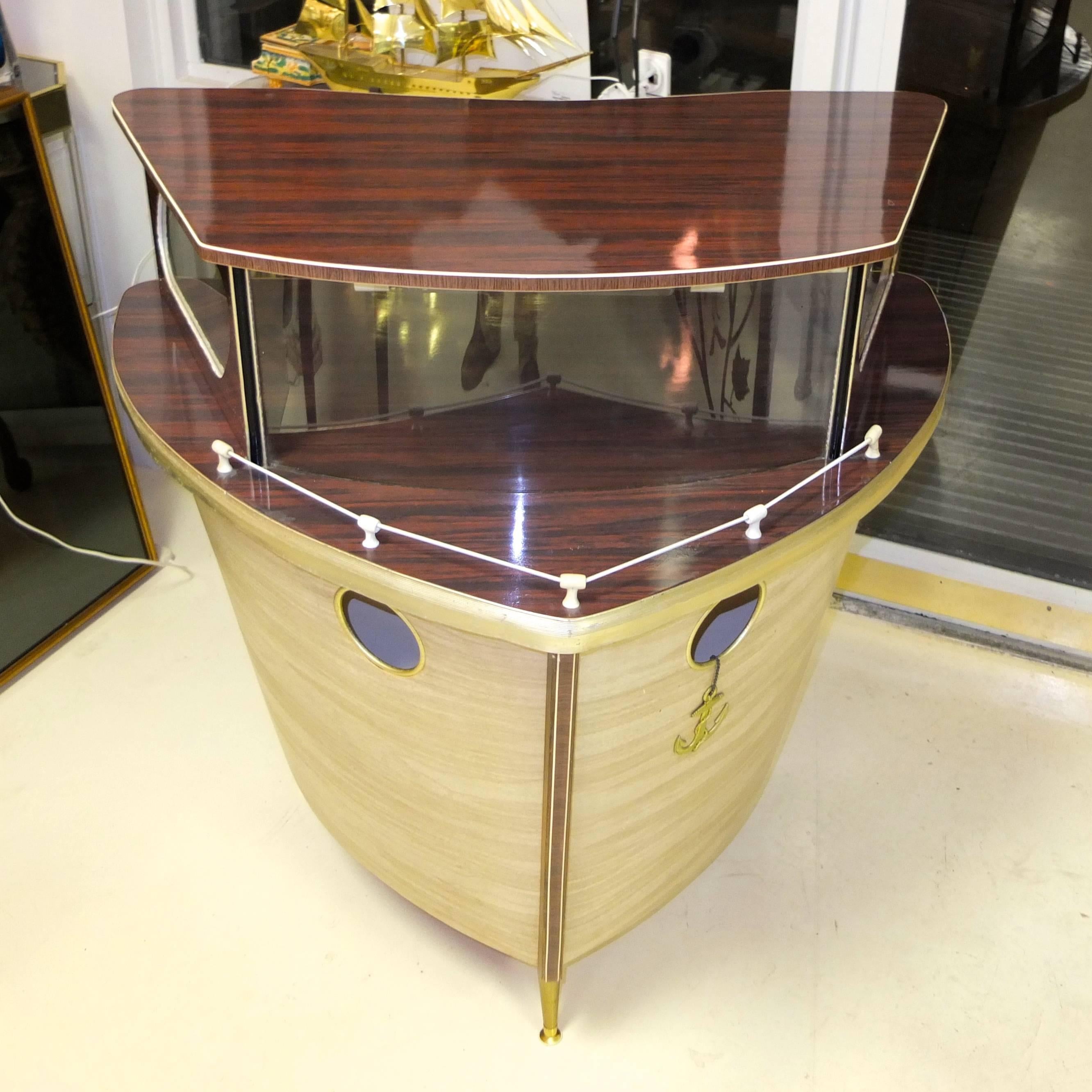 1950s standing cocktail bar by Umberto Mascagni of Bologna, Italy and imported to the UK (later, possibly produced by) by I. Barget Ltd. then retailed through Harrod's. 

Cocktail bar in the form of the bow of a cabin cruiser on three tapered