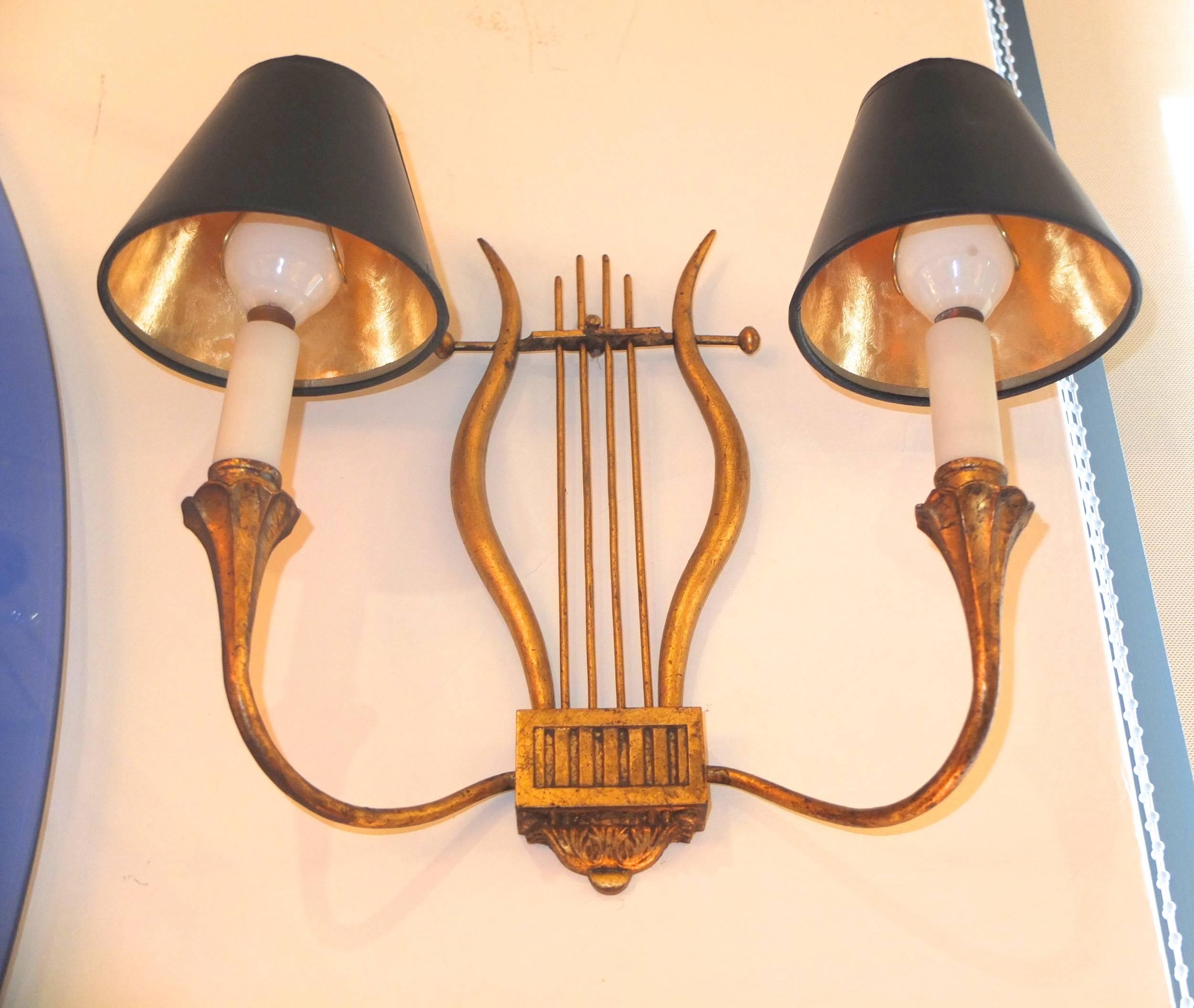 Pair of gilt iron appliques in the form of a lyre created by Marc du Plantier for a private apartment in Madrid, 1940s.
Two pair were created for this apartment, described as neoclassical Avant Garde modernist. We are fortunate to have this pair