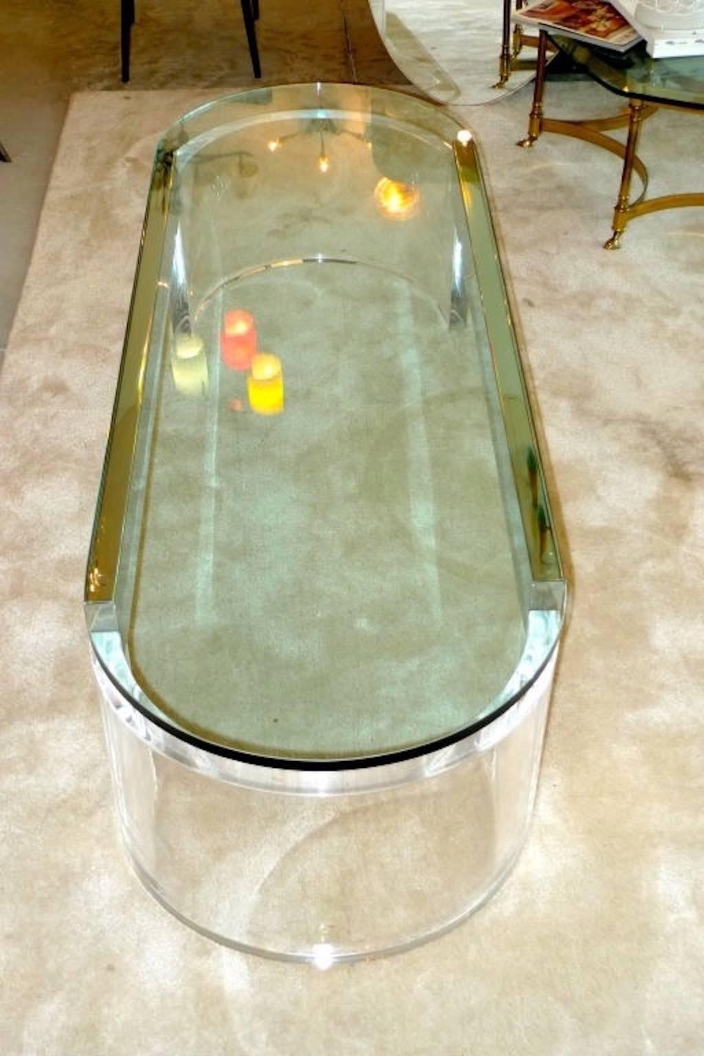 Superb designer cocktail table designed by Raymond Jurado,  produced by Gary Strutin in New Rochelle, New York and sold through Paul Associates NYC in the late 1970's.  Racetrack elongated oval heavy 1 inch glass top across a pair of 1.5 inch thick