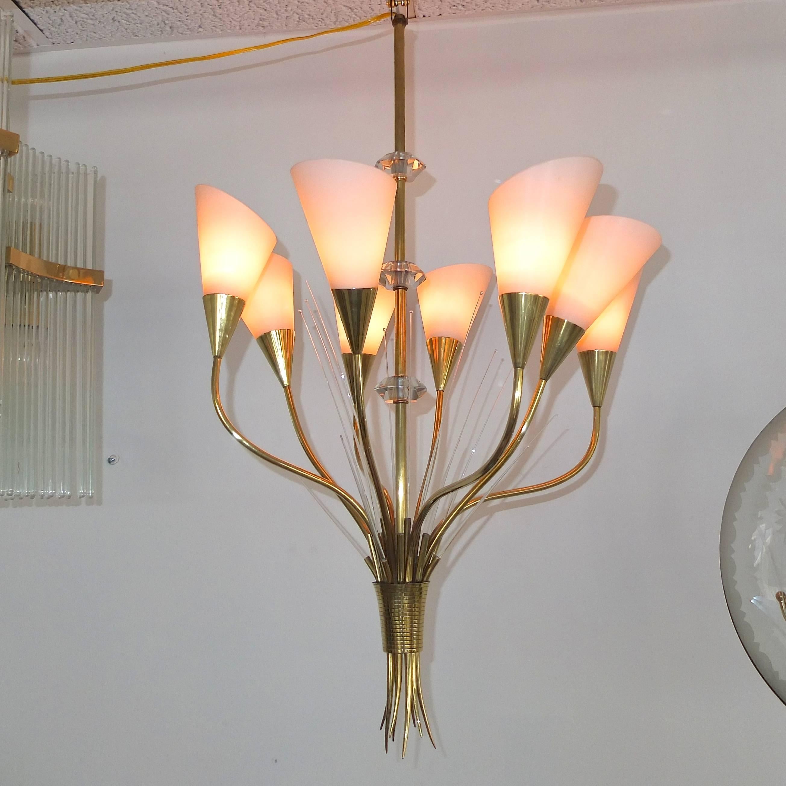 Very rare original chandelier from Maison Arlus, France, circa 1955. Chandelier is in the form of a bouquet of flowers. Eight arms bent organically to represent long stems with white satin glass shades like lily flowers inside brass cone base. The