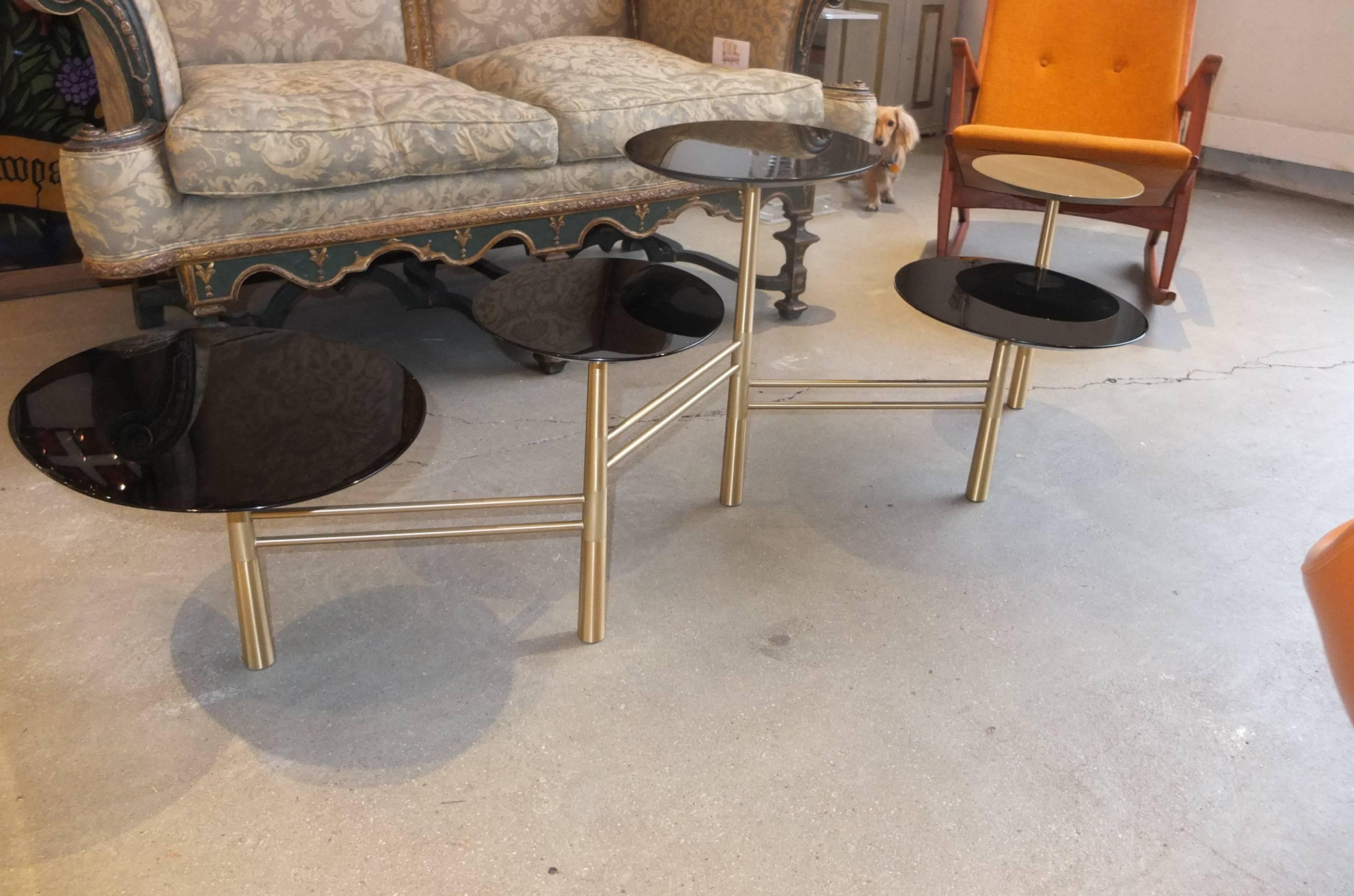 The pebble table by Nada Debs. Five top on solid brass base. Four black lacquer pebble tops and one brass. Signed by the artist.

Just installed in BG Galleries' market stall in the Boston Design Center, this particular table is available for
