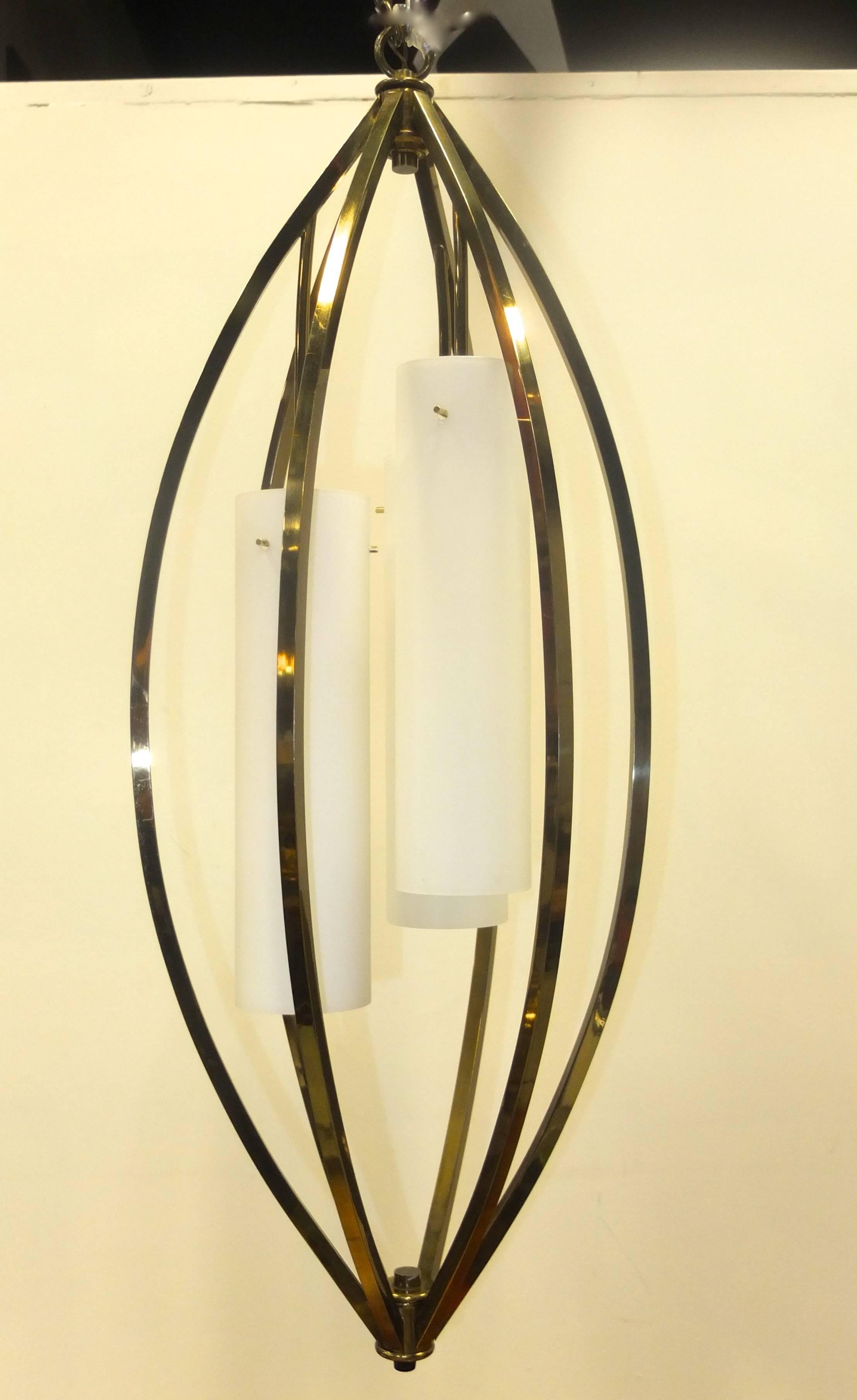 Unusual 1960's vintage pendant in the form of a vertical oblong brass framed balloon or birdcage fitted with three lights inside Italian white opaline LV glass cylinders each of which is 13-7/8 inches long (35.5cm) and 3.5 inches diameter with three
