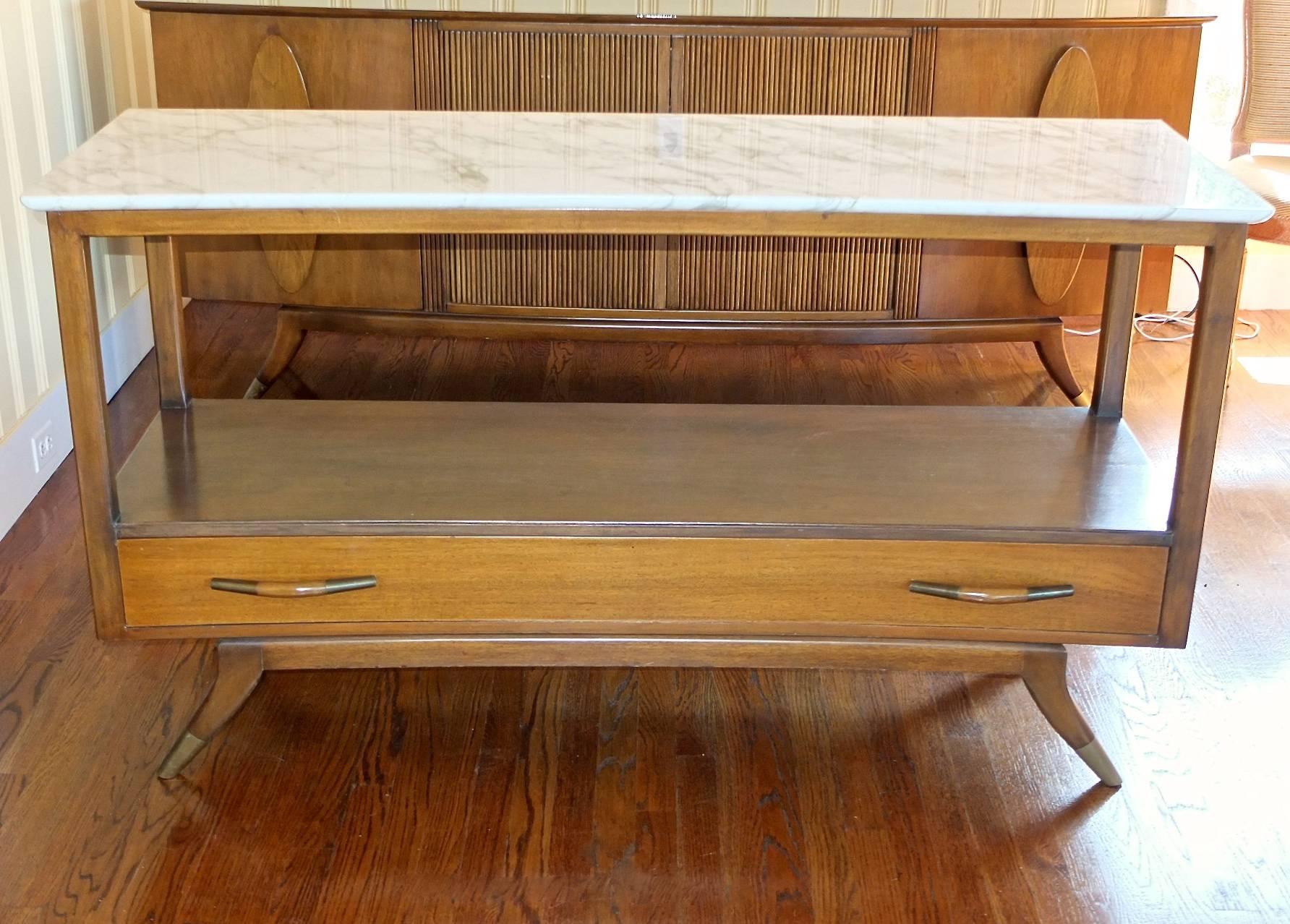 SATURDAY SALE

Walnut open face buffet server table with slight convex front and marble top held aloft a long single drawer with sculptural pulls, all of which floats on four tapered horn shaped legs, the front two with brushed brass sabots. Note