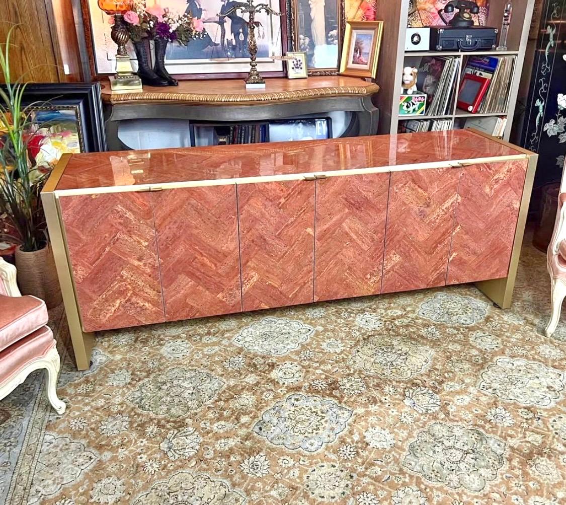 Trophy piece. Uber rare. Six door sideboard designed by O. B. Solie for Ello Furniture.
Top and door faces clad in polished red Persian travertine marble set in a herringbone pattern. 
Slab supports and doors trimmed in brushed brass.
Three open