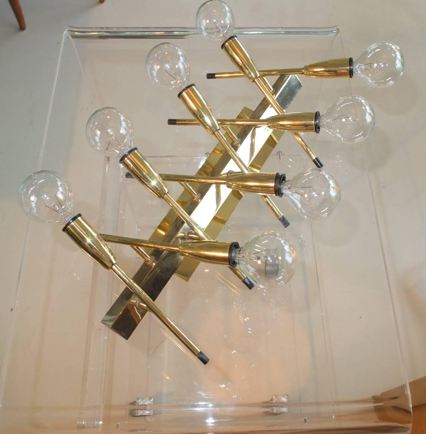 1950s Italian brass wall lamp consisting of eight individual brass cones on brass stems mounted on a length of brass angle. Can be mounted horizontally, vertically or even diagonally. The fixture is mounted by first screwing two small L shaped