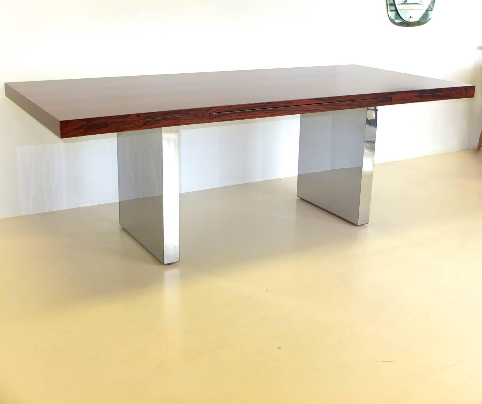 
Rich beautifully grained rosewood top with three drawers on double plinth bases clad in polished chromed steel sheet.

Extremely solid and robust construction. Like Stonehenge!

See our separate listing for the matching credenza.

If