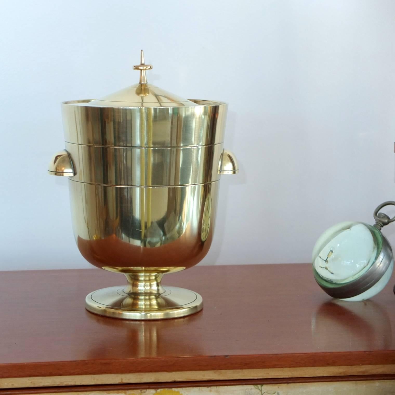 Tommi Parzinger designed lidded brass ice bucket or bottle cooler with original mercury glass thermos liner. Produced by Dorlyn Silversmiths pre-1955.

Not a bad looking cremation urn either!