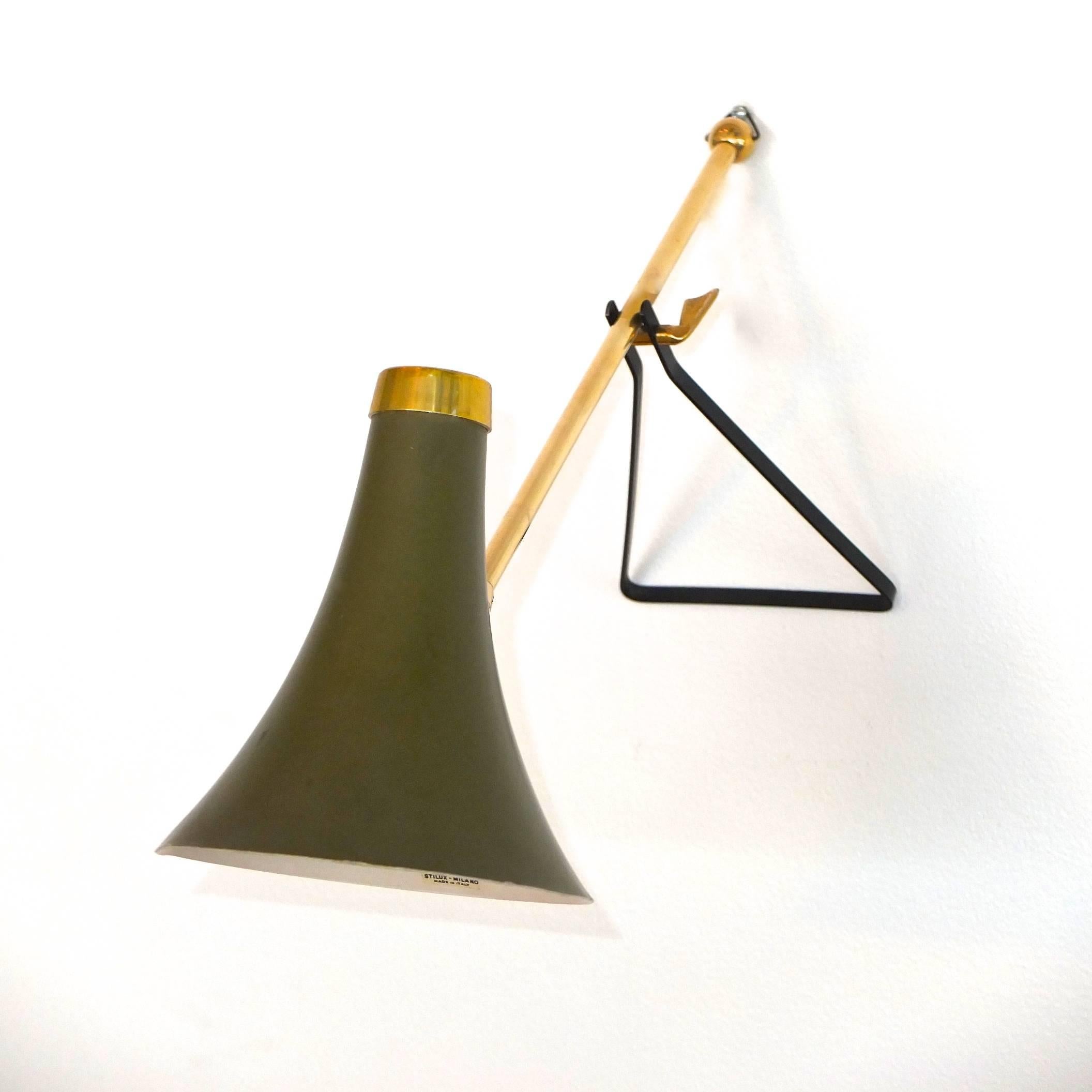A very rare lamp from Stilux Milano with tapered bell shaped aluminum cone in its original olive green paint and the original label present inside. This lamp is multifunctional as it can be used as a wall sconce or as a table lamp. The single socket