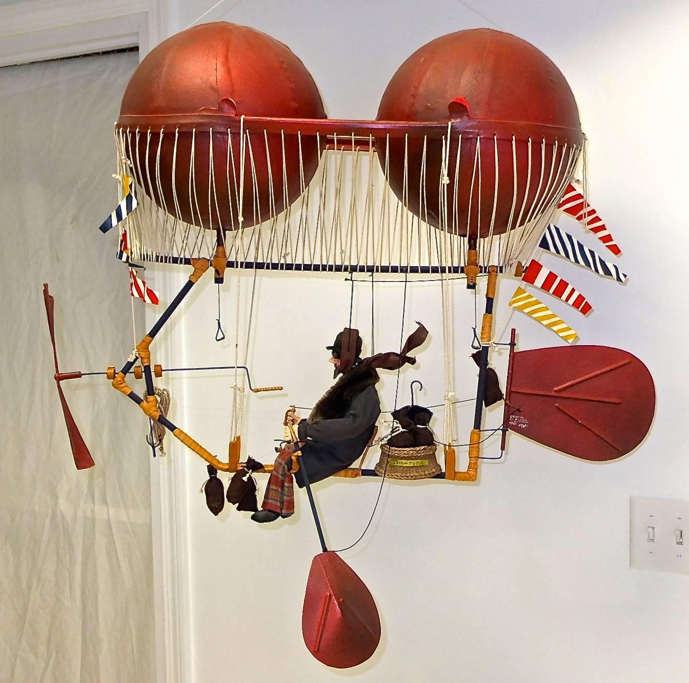 Signed original Kinetic mobile sculpture called “L’Adventure” by Claudia Marchesin & Serge Reynaud, 1989, from their Art of Flying series. 

Marchesin and Reynaud use art, science and imagination to create fantastic flying machines, taking