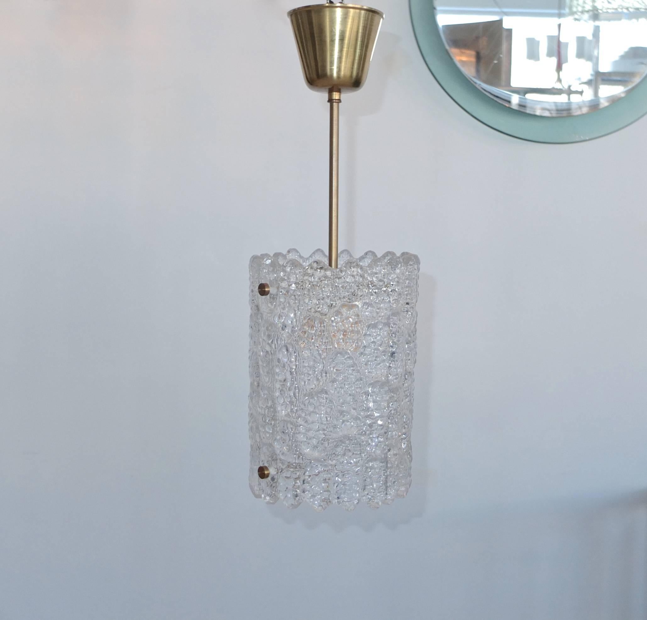 A Swedish crystal pendant light with brass hardware by Carl Fagerlund for Orrefors, Sweden. Late 1940s-early 1950s.

Total height including canopy is 20 inches. Glass only is 10 inches high by 7 inches diameter.

Takes a single standard size