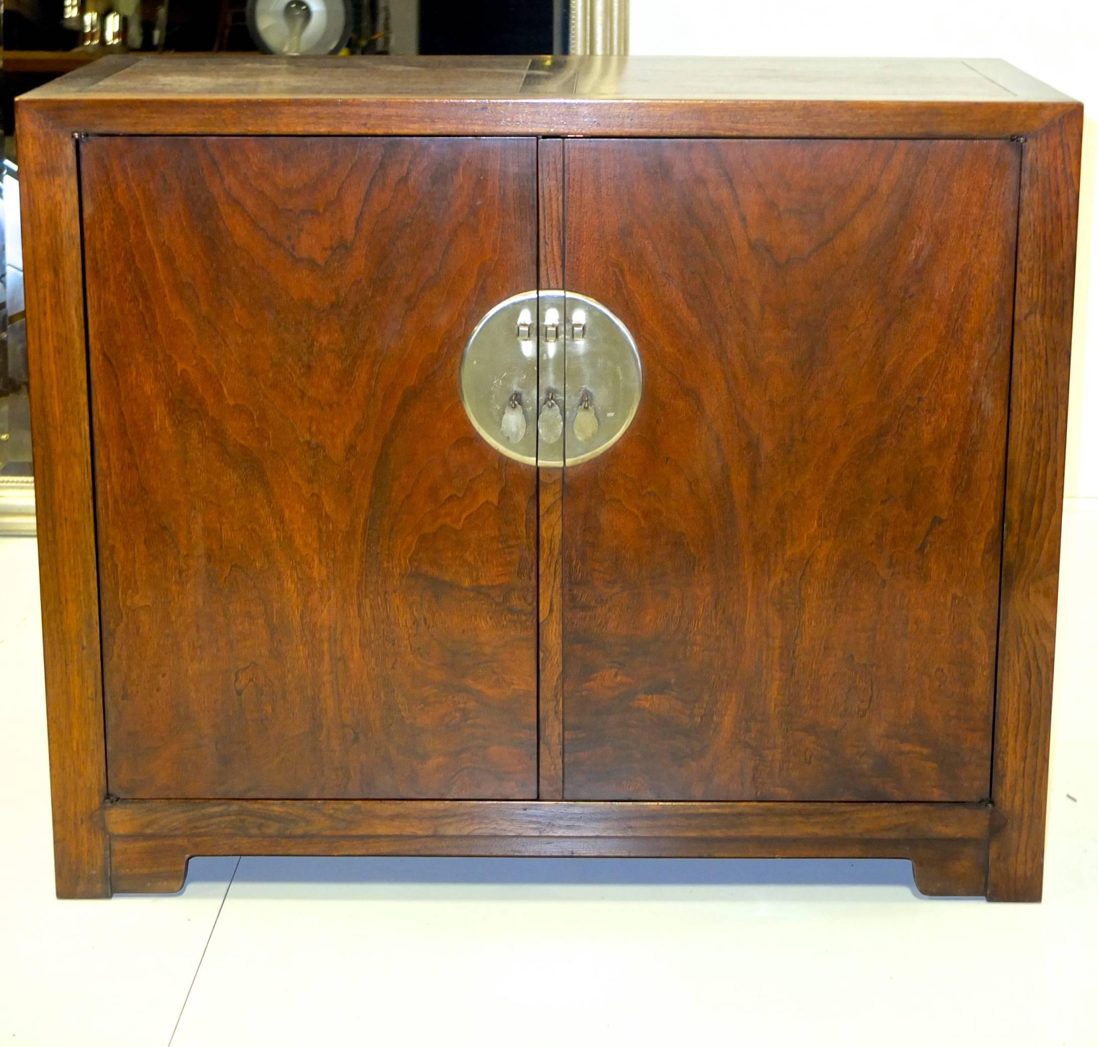 Walnut two-door cabinet with distinctive nickel hardware from Baker's Far East Collection designed by Michael Taylor (see image 10 for original Baker catalog page). First produced in 1949 and continued through the early 1960s. Classic modern with