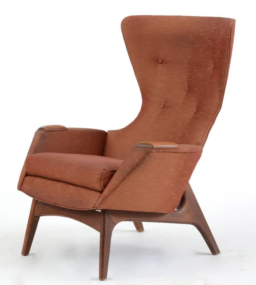 One of the chicest and most sculptural wing chairs ever created and nearly impossible to find.

Solid walnut sculptural frame supports this egg-like chair of foam rubber over molded plywood. Loose seat cushion over straps. Solid walnut