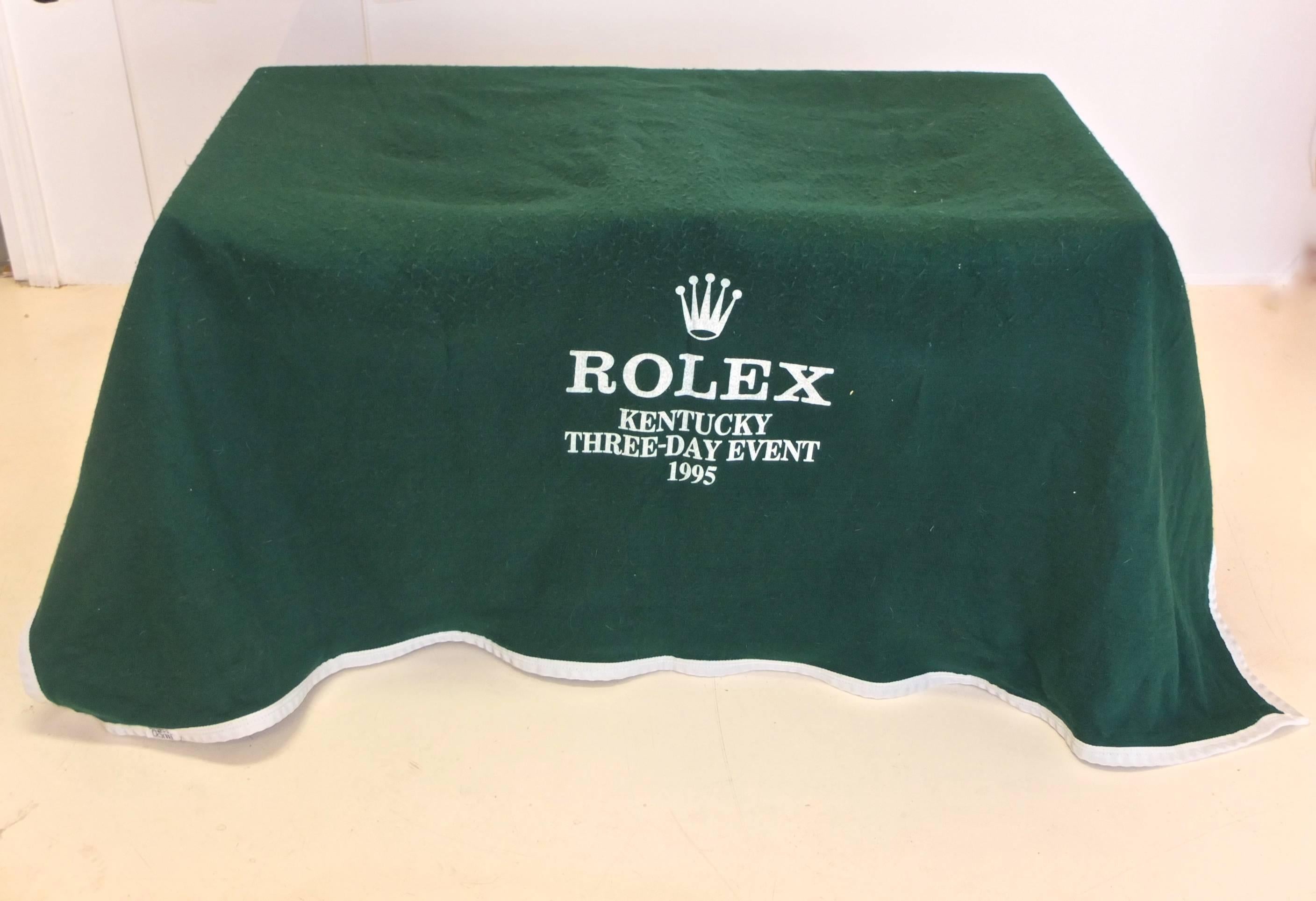 A forrest green felt horse blanket with white nylon trim and straps from the famous Rolex eventing championship. The model is Roma from Miller's Harness Co. Printed on two sides with the Rolex crown and Kentucky Three-Day Event 1995. 

It is huge