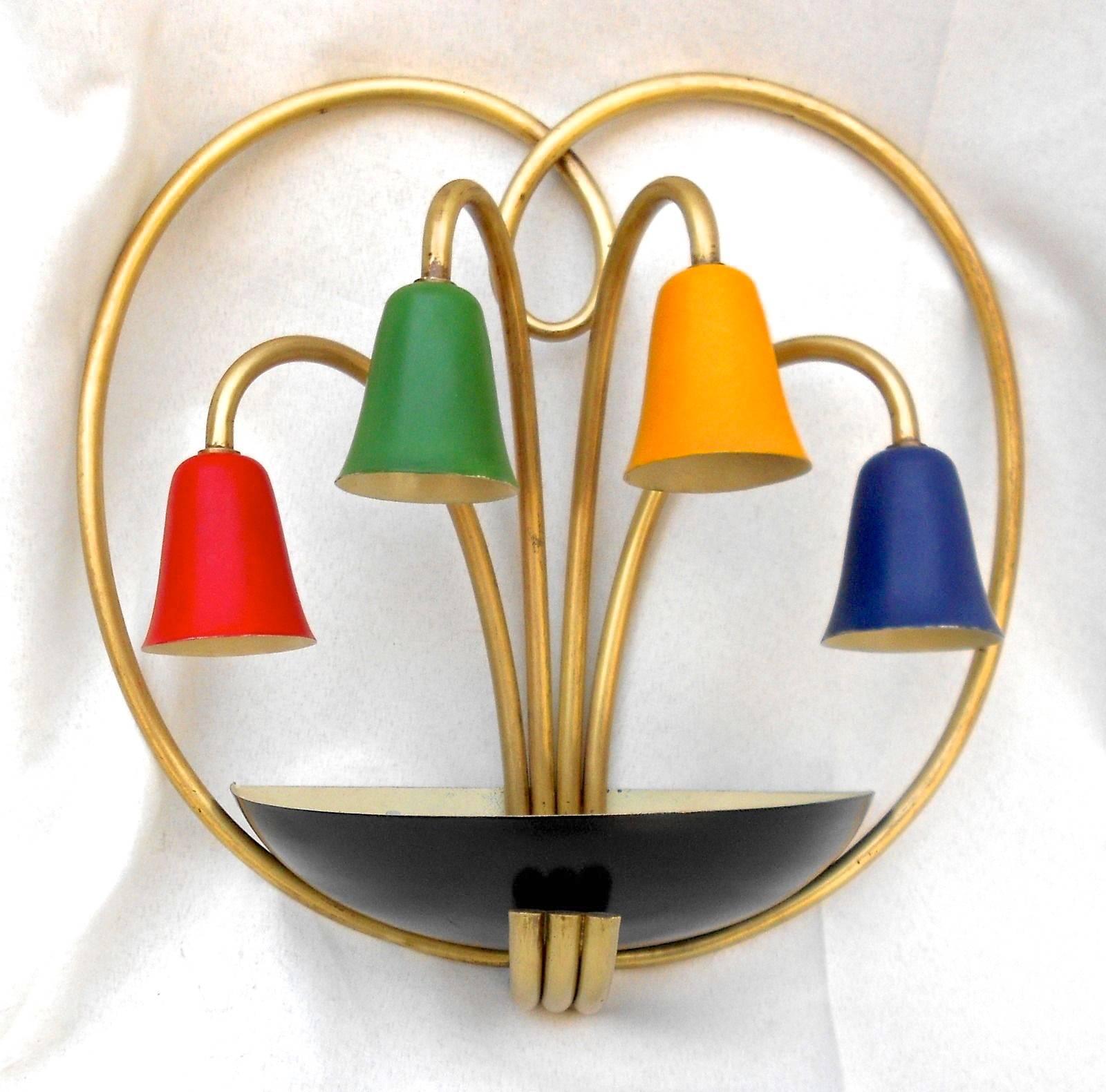 Unusual Italian wall-mounted lamp from the 1950s with bent brass tubing and four colorful enameled aluminum cones like lily flowers above a black enameled aluminum bowl into which artificial leaves may be placed.