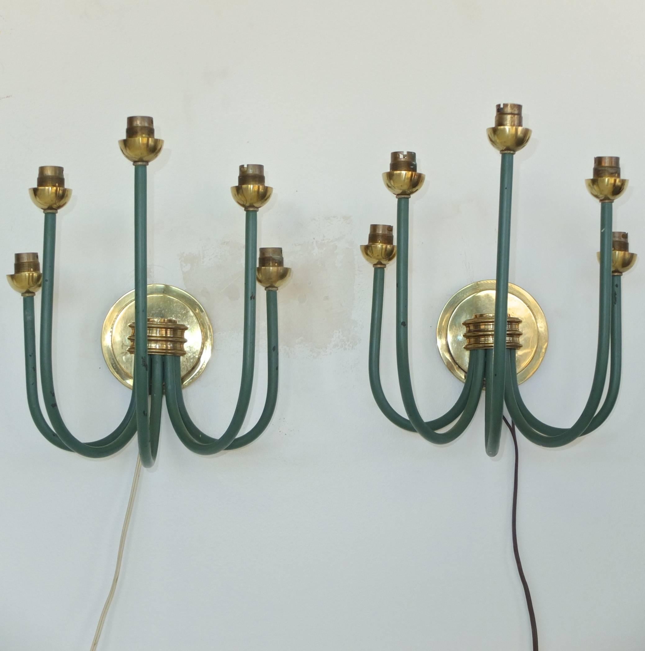 Striking and generously proportioned vintage French candelabra sconces in the style of Jean Royère, 1950s.

Hefty brass round backplate with brass cluster mount, from which sprout five upwardly curved candelabra arms of ascending/descending height
