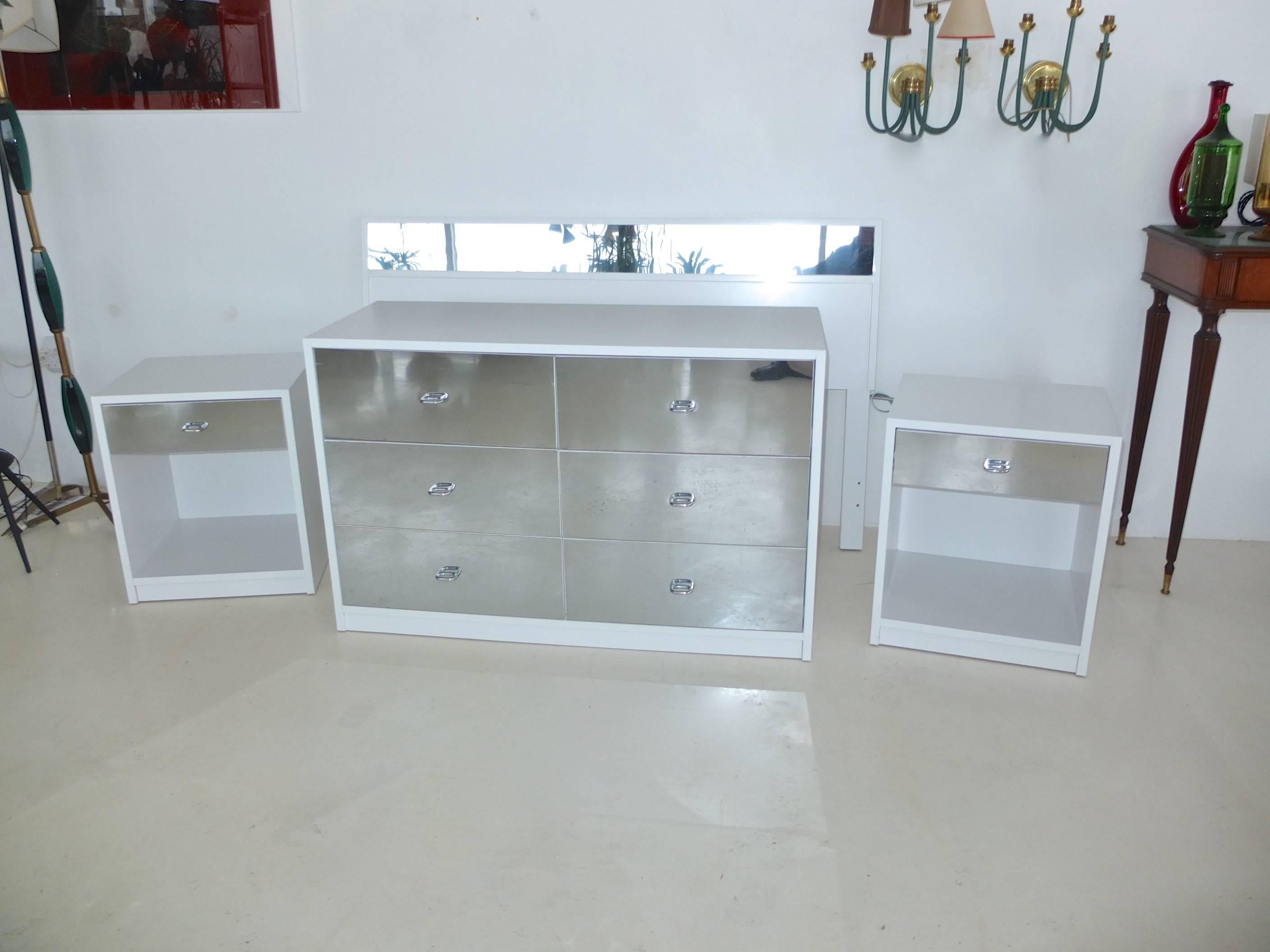 Produced in 1963 for Charak modern, a clean bedroom set with Pierre Cardin glam. Crisp white painted wood cases with mirror faced drawer fronts and headboard. Freshly repainted by professional cabinet finishers. Set consists of a Full size