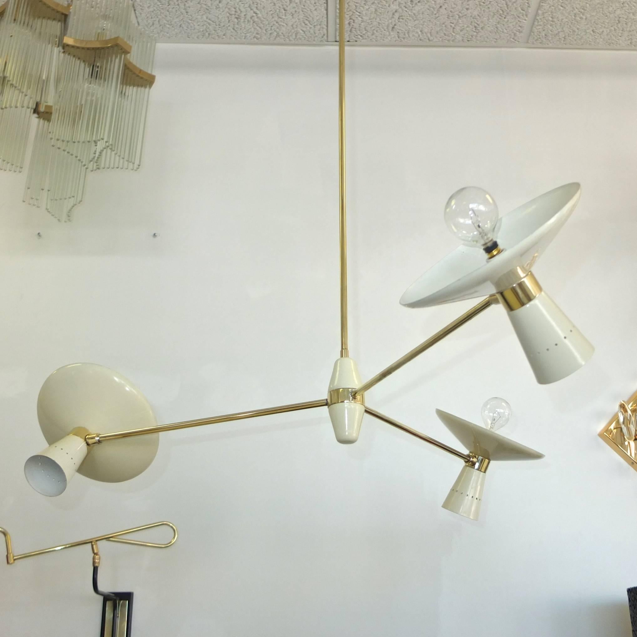 1960s Italian three-arm suspension chandelier by G.C.M.E. (Giulio Compagnini Montecatini Elettricita`)

Suspended by a brass rod to a double cone and brass cluster body off which radiate three fixed brass 13 inch arms terminating with brass swivel
