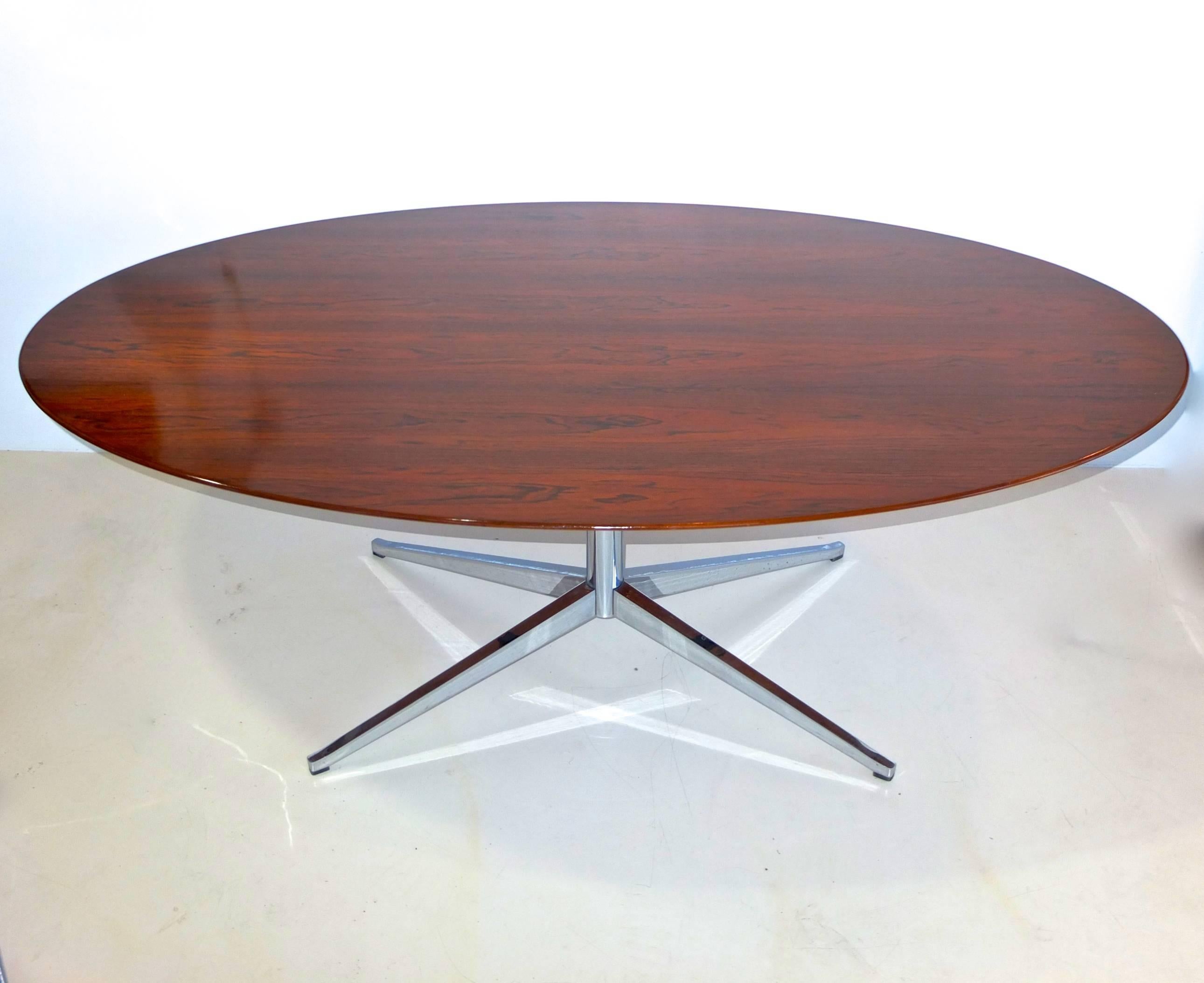 Florence knoll oval dining table or desk in Brazilian rosewood on polished steel pedestal and four star base.

Original knoll label on underside. 

Restored and ready to use.

Florence Knoll designed this iconic desk to free the executive