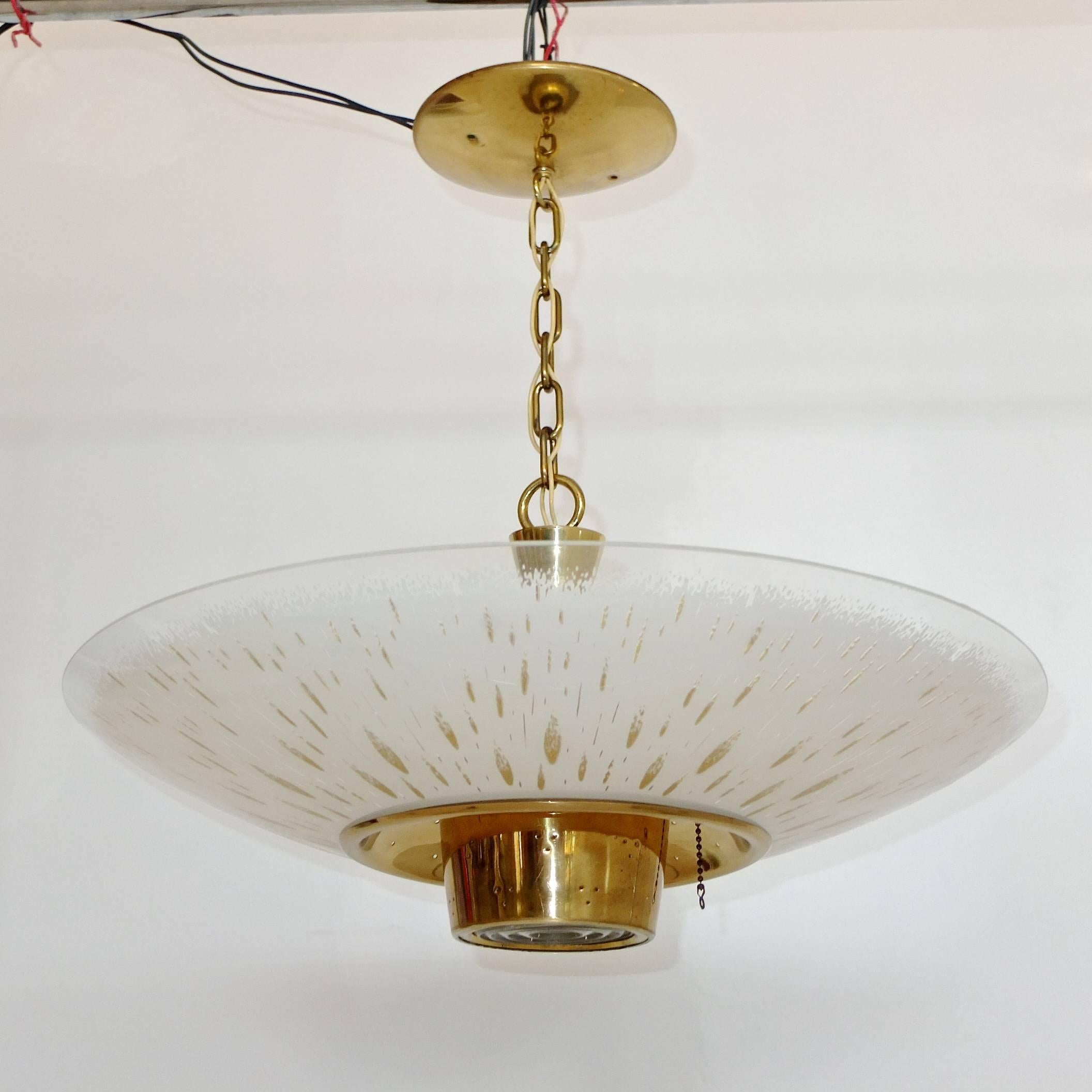 Lightolier flying saucer ceiling light, suspended flush mount, brass and enameled curved glass with gold flecks.  Takes up to 3 100 watt bulbs. Note pull-chain next to center lens.  9 inch drop when used as a flushmount and 18 inches drop with