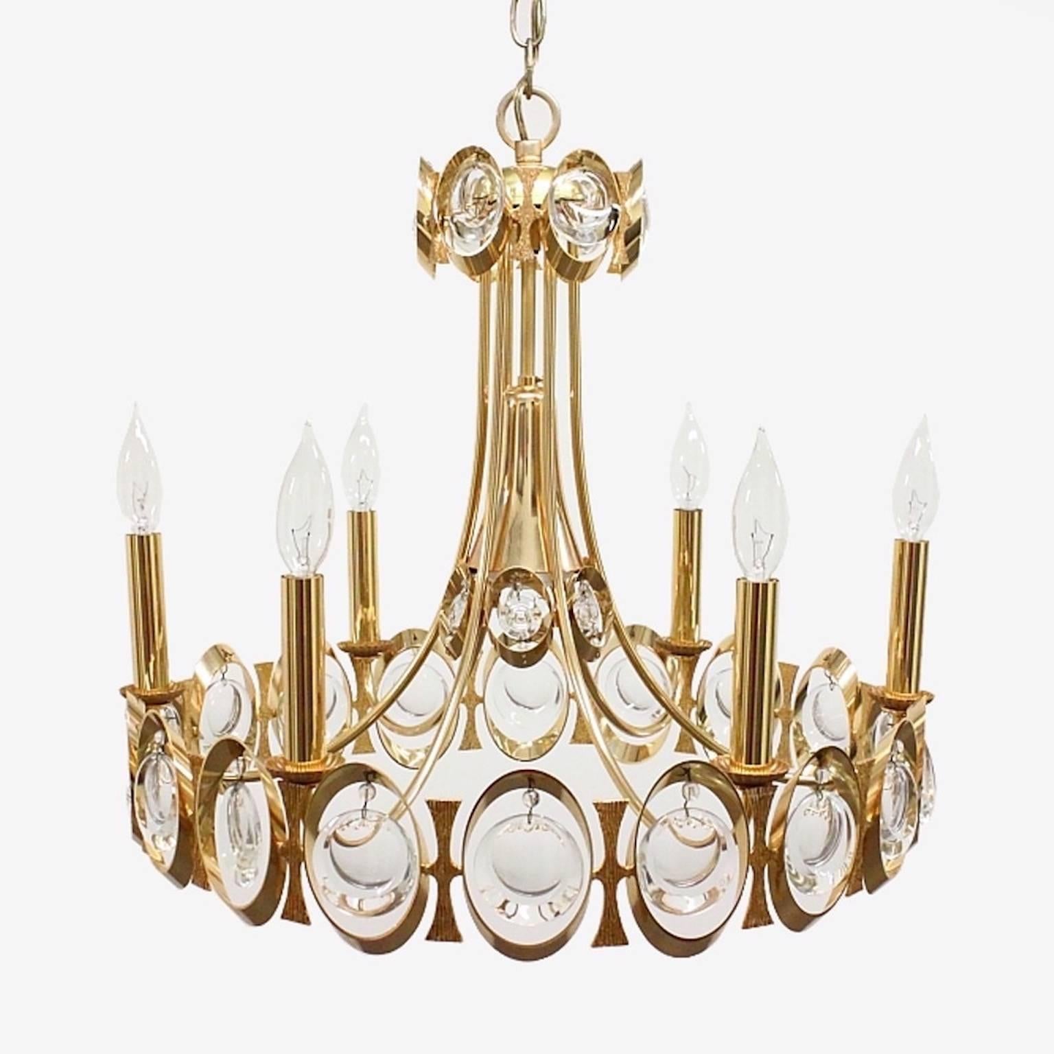 Vintage glamorous 1960s chandelier by Palwa of Germany. Round venturi shaped with interlinked gilt brass oval rings in which dangle the wheel ground optic lens prism crystals. 
This chandelier has six candle lights (up to 60 watts each) and a single