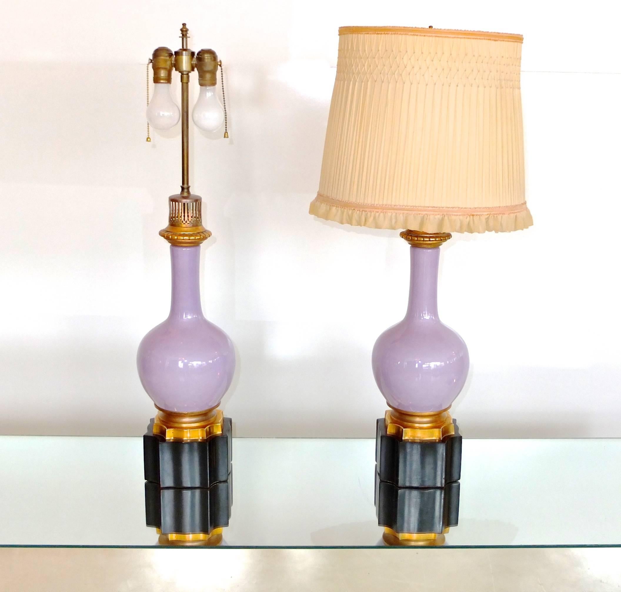 Truly beautiful pair of lamps. Lilac purple porcelain bottle form vases on ormolu mounts standing on octagonal black onyx base.

Brass double cluster lamping with adjustable height shade stem. On/Off by pull chain or cord switch.

These lamps were